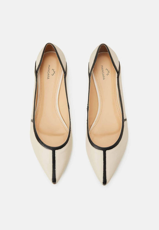 Pair of white pointed-toe shoes with black accents on a light gray background