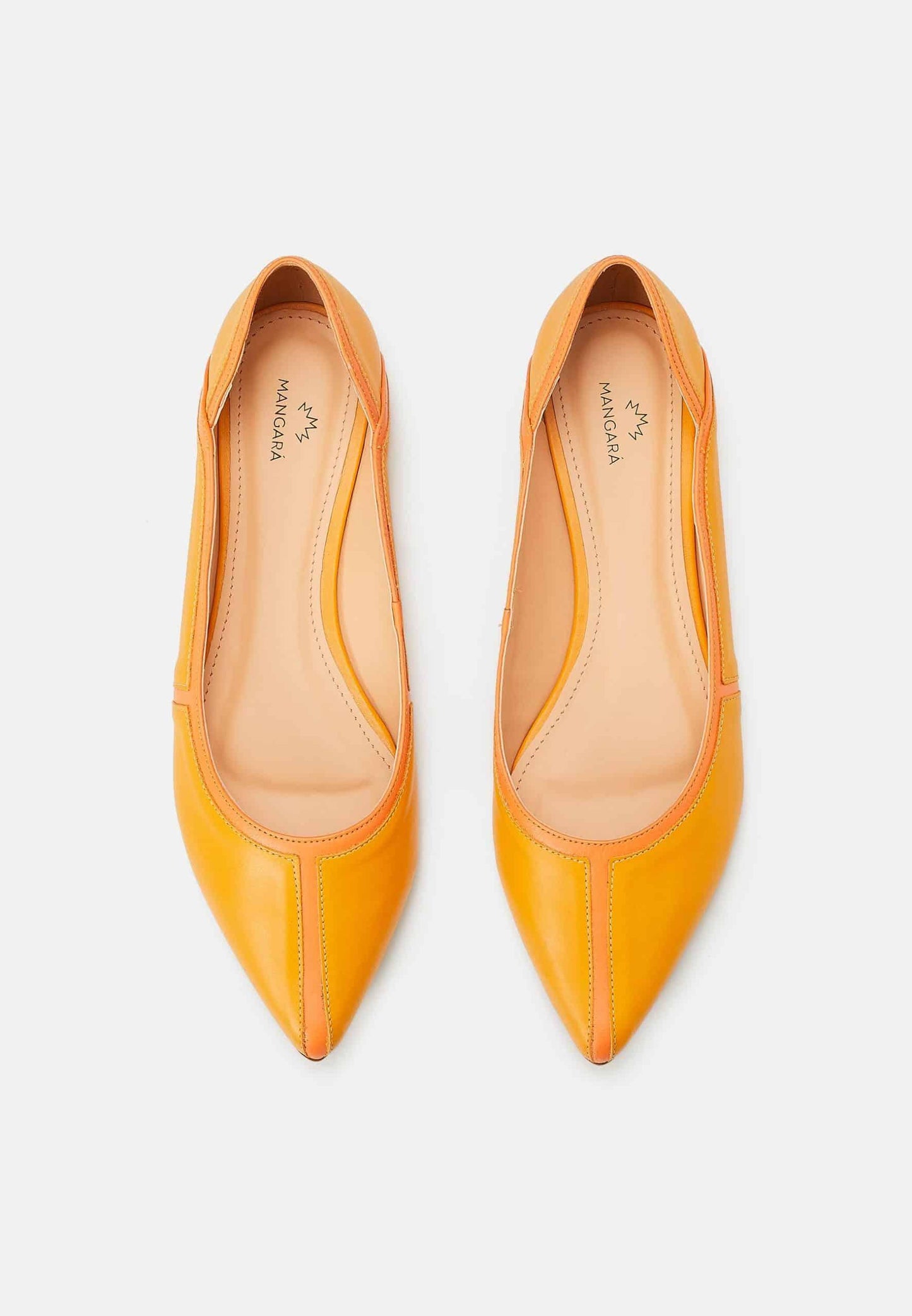 Pair of yellow pointed-toe flats on a light gray background