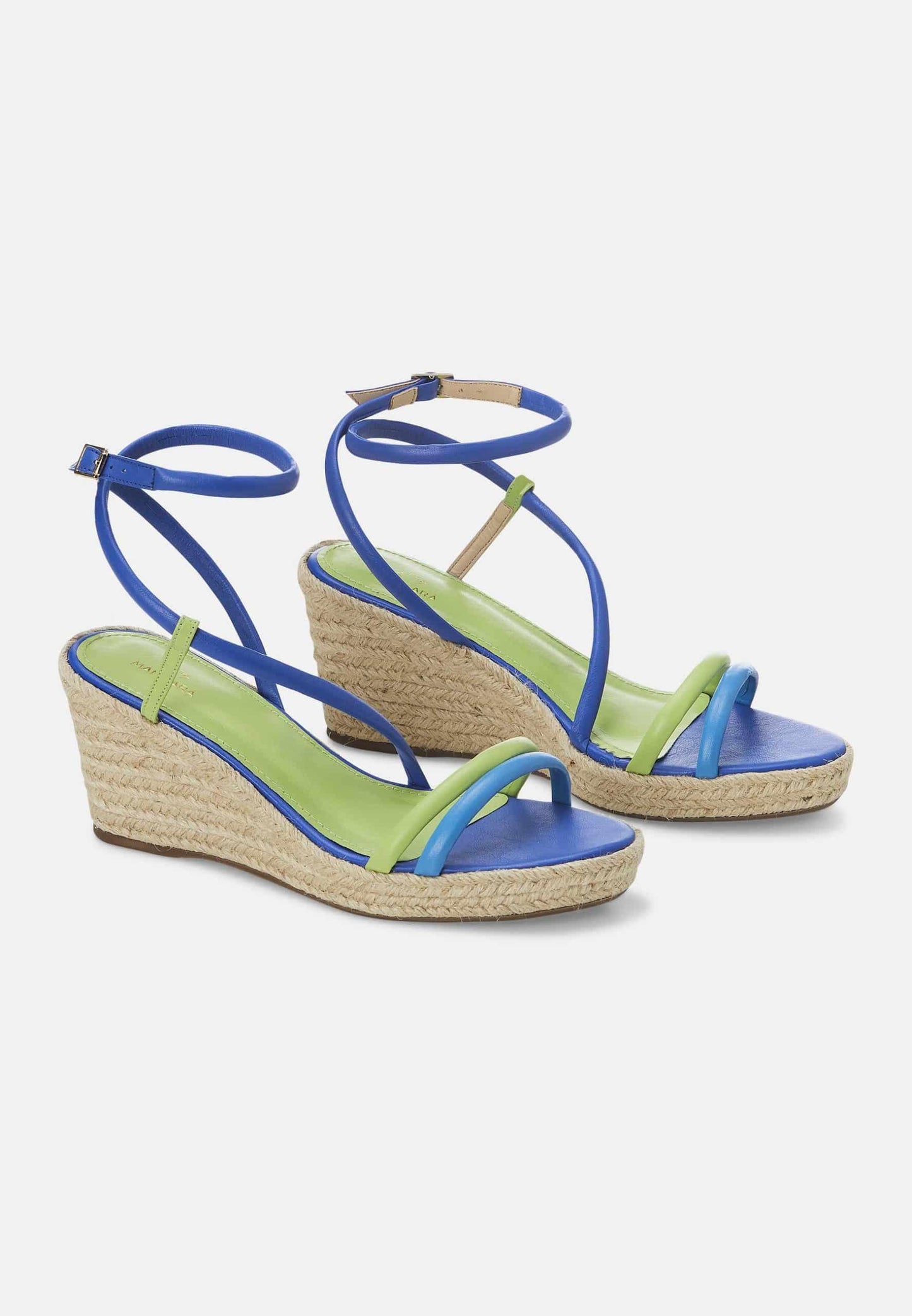 Blue and green wedge sandals on a white background