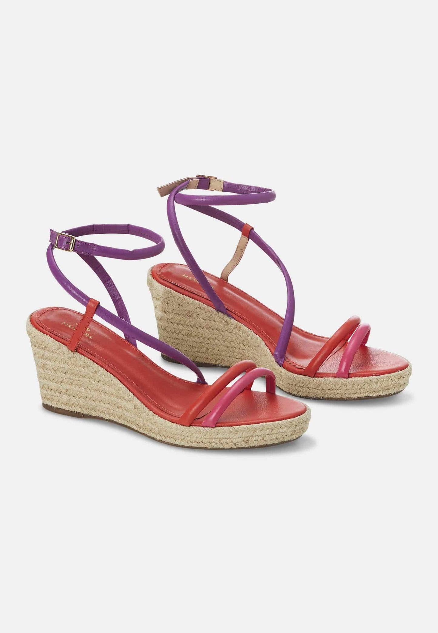 Pair of colorful wedge sandals with purple straps on a white background