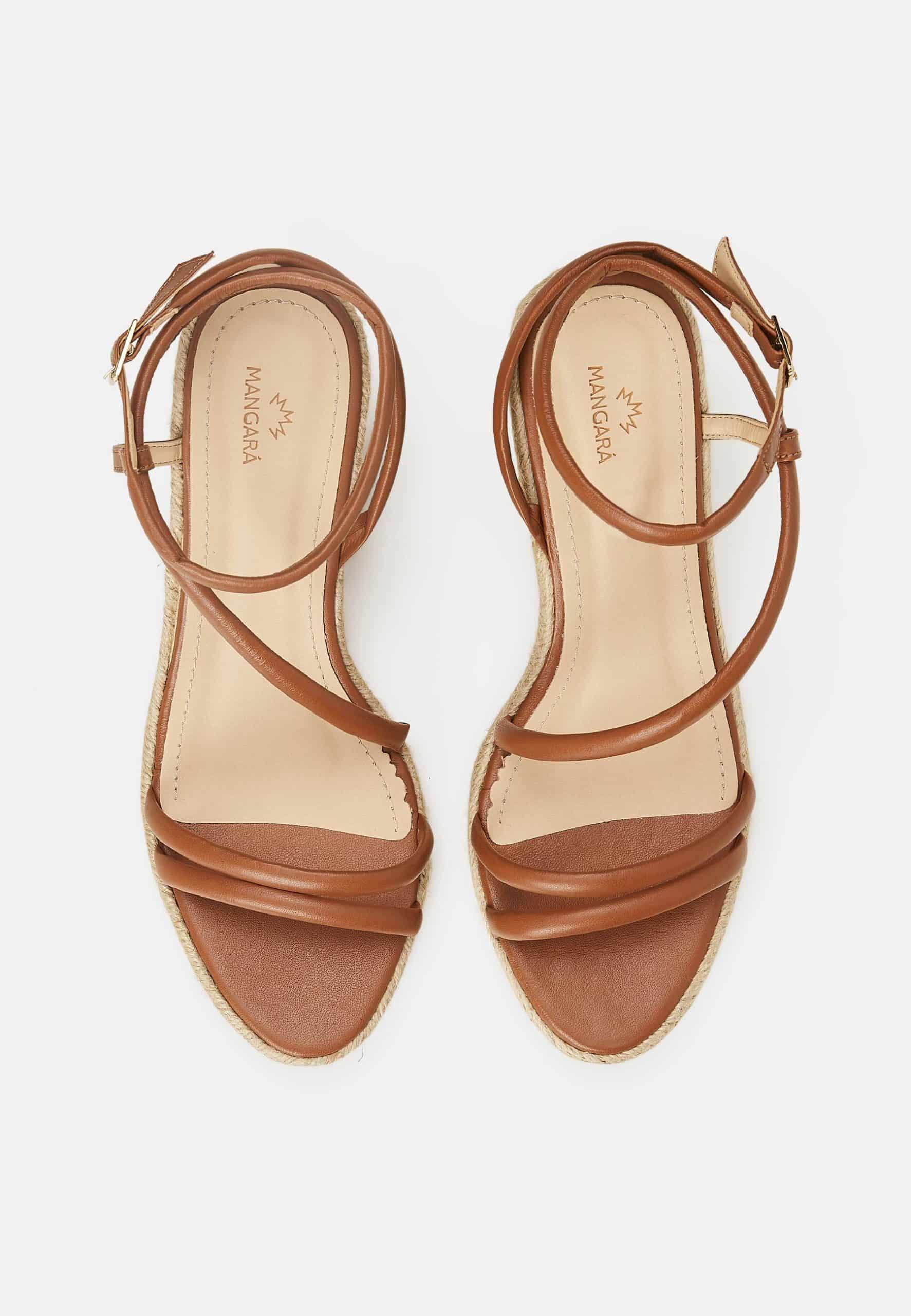 Pair of brown strappy sandals on a white background