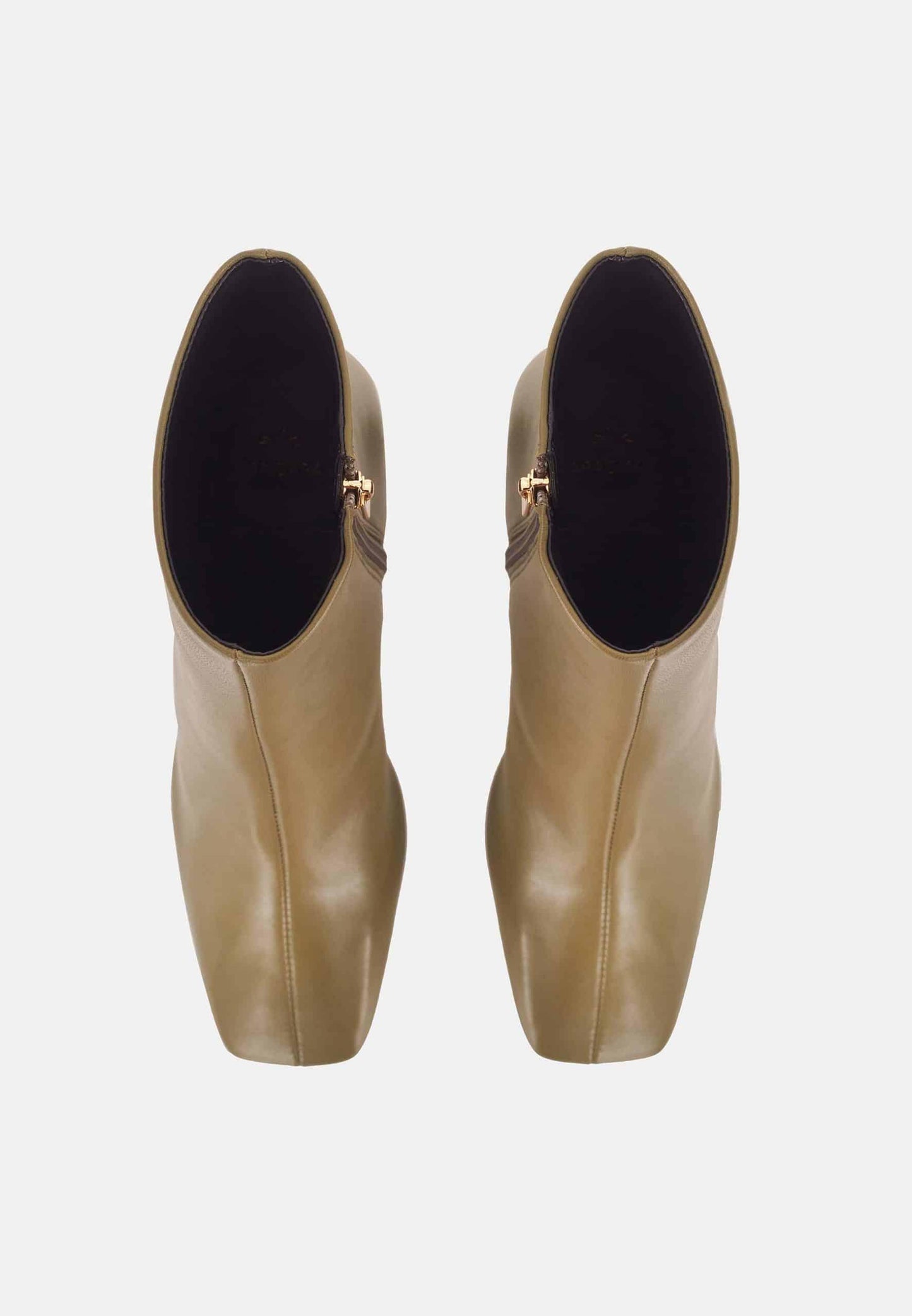 Pair of beige ankle boots with black soles on a white background