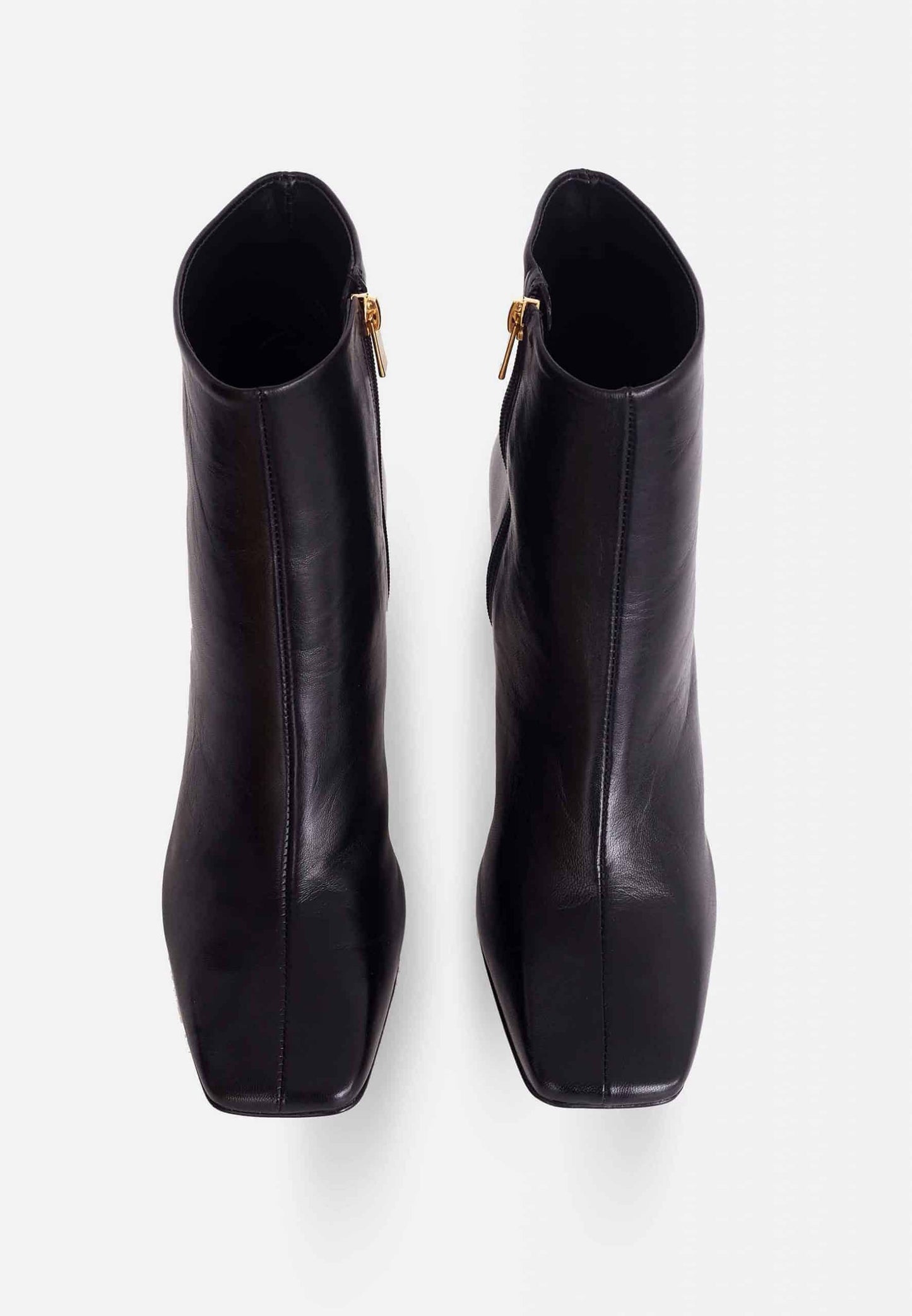 Pair of black ankle boots on a white background