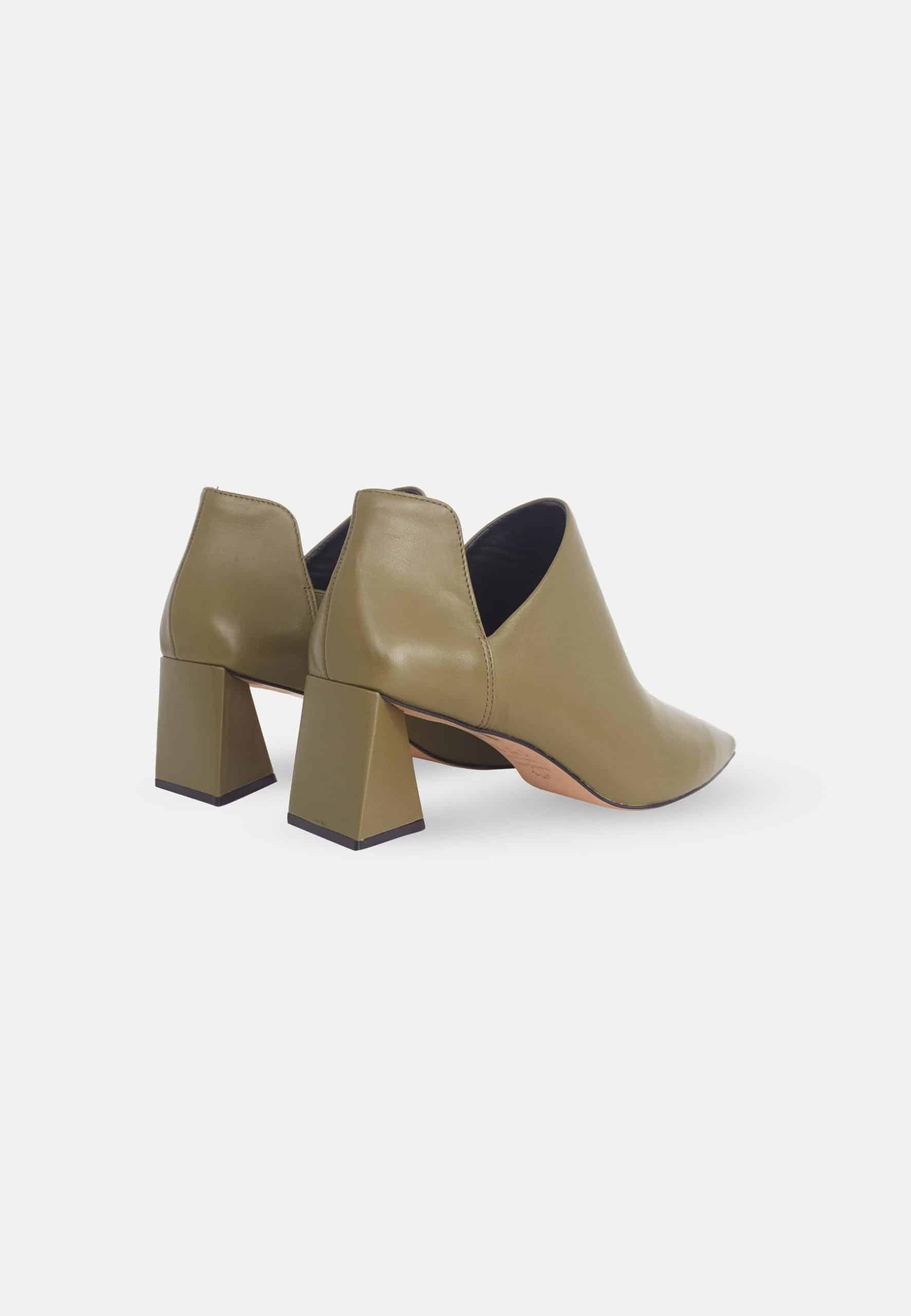 Pair of beige ankle boots with block heels on a white background