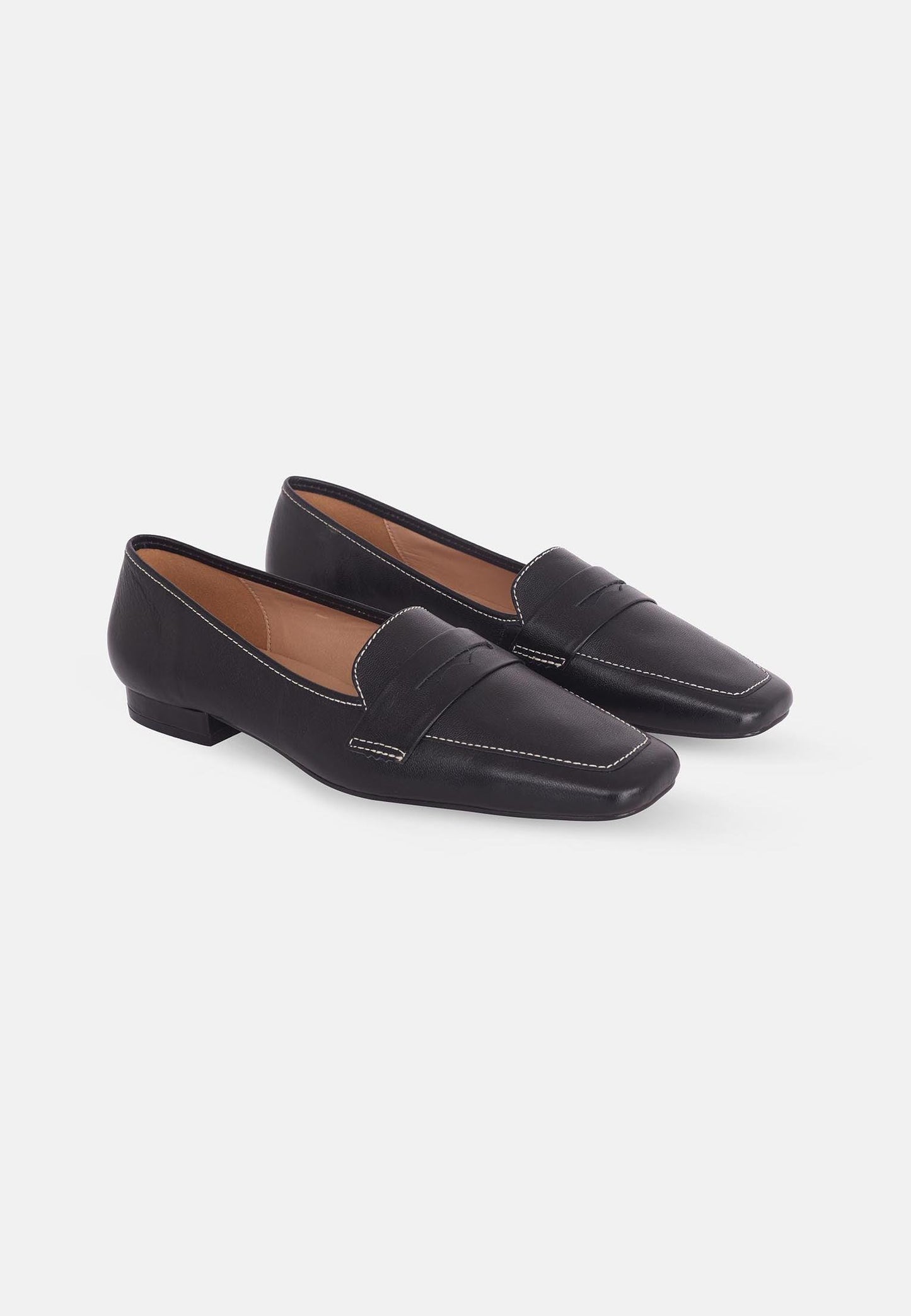 Pair of black loafers on a white background