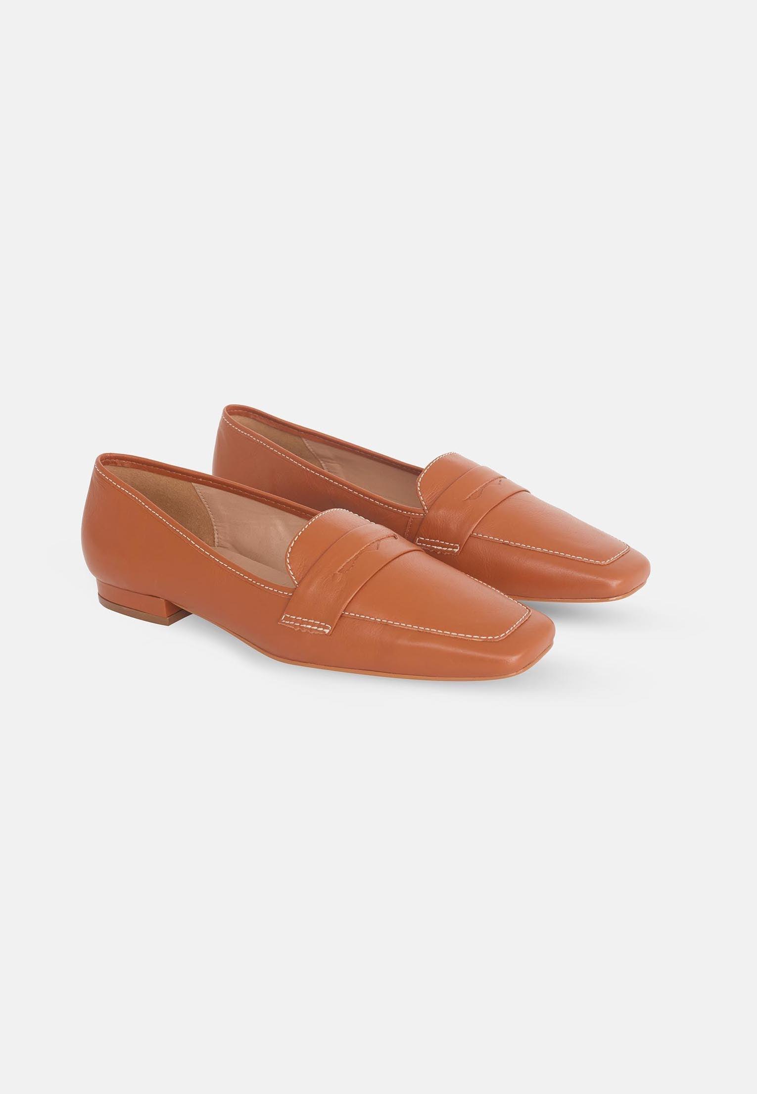 Pair of brown loafers on a white background