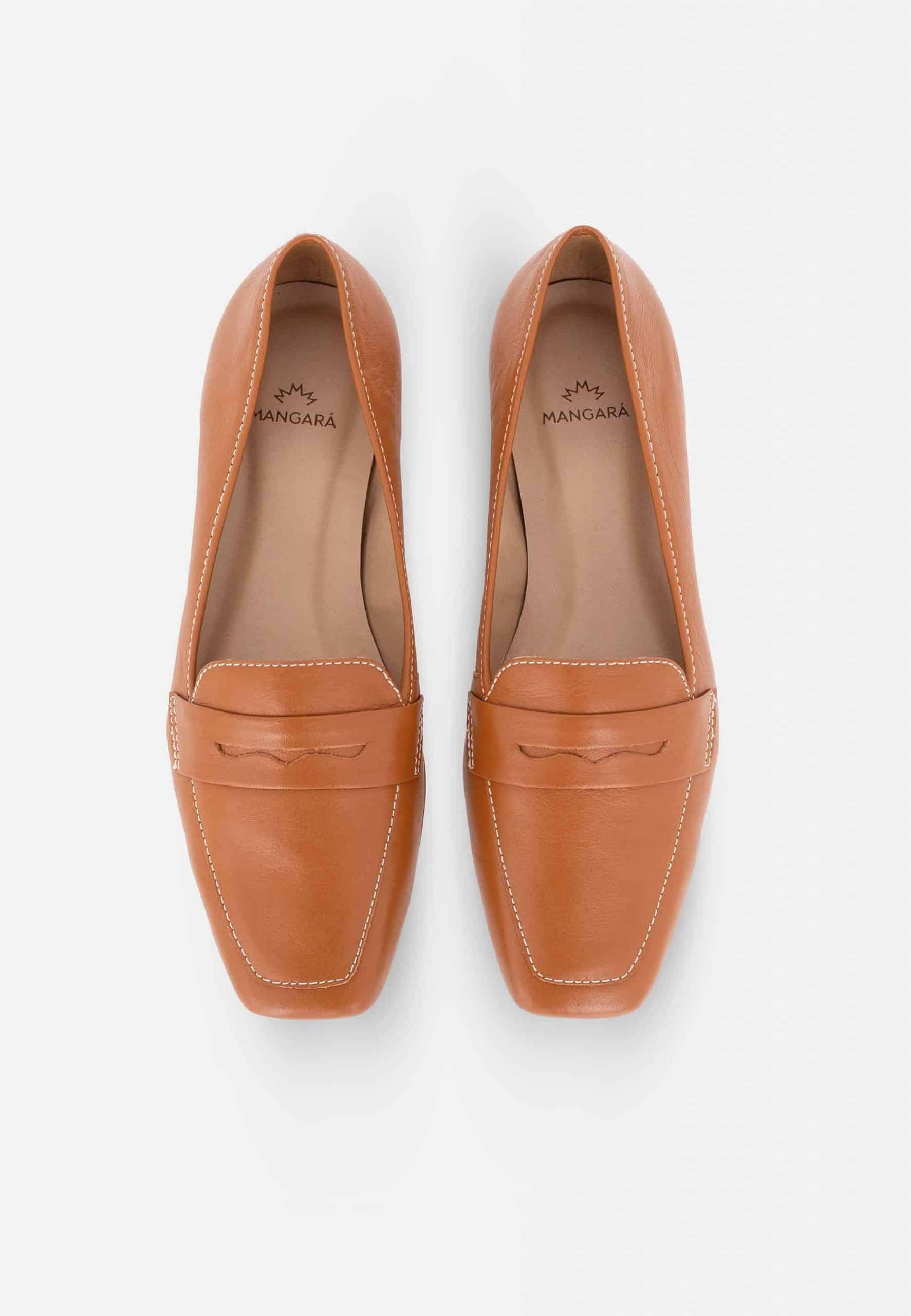 Pair of tan loafers on a white background