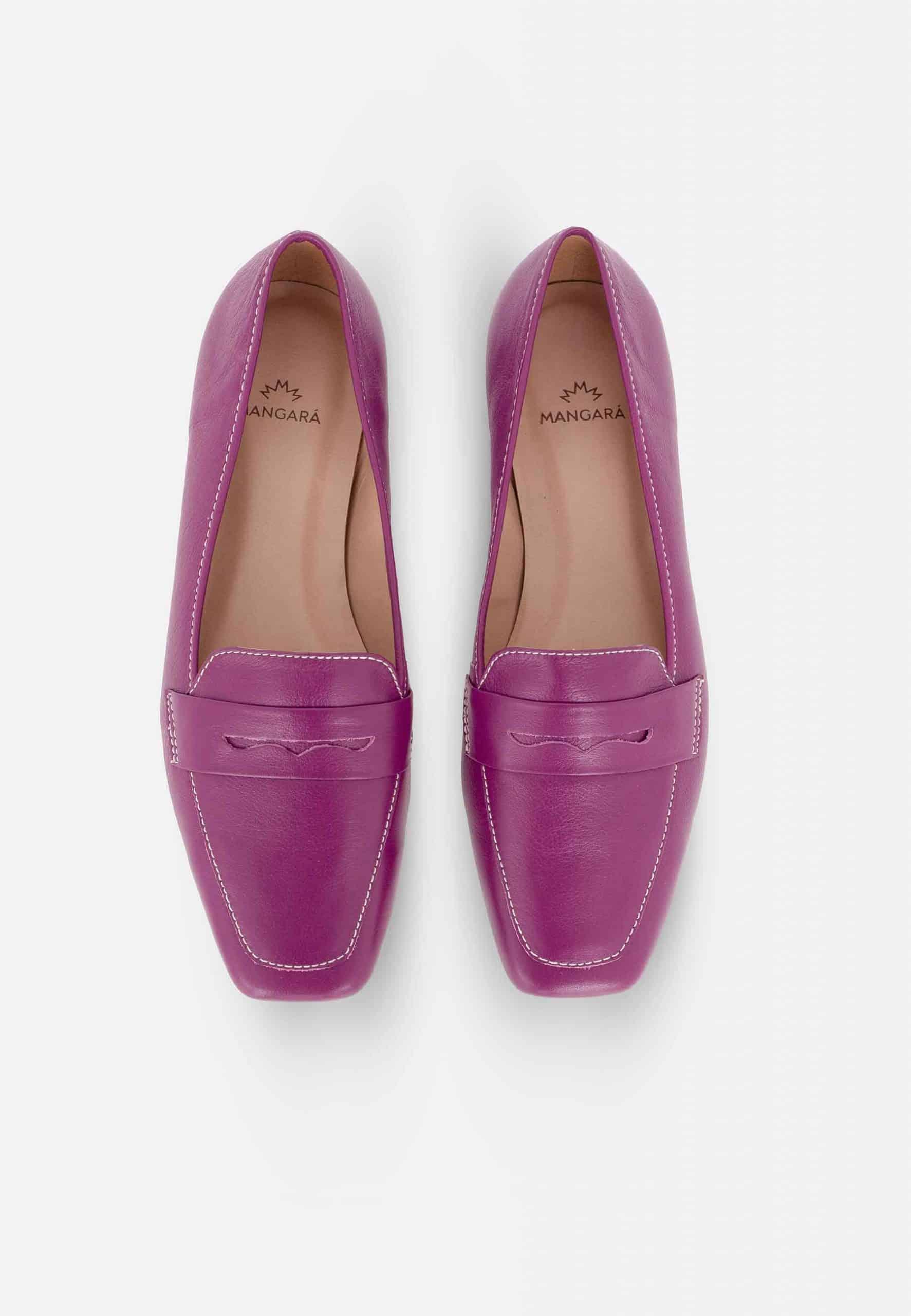 Pair of purple loafers on a white background