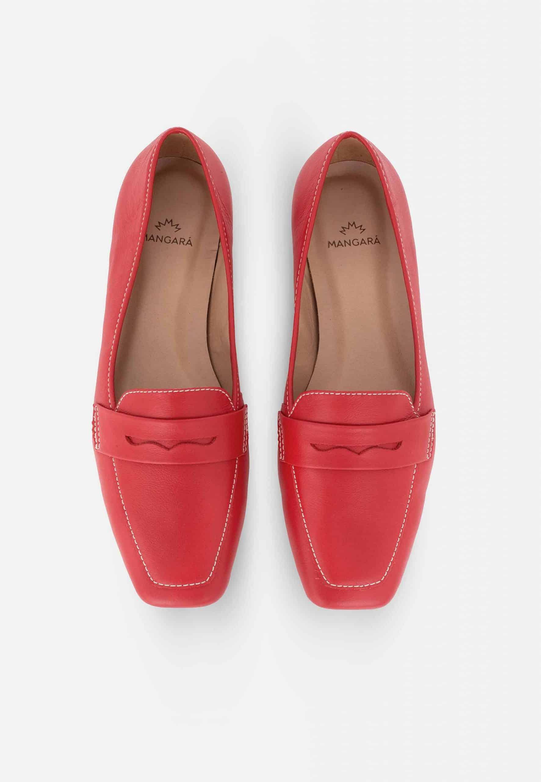 Pair of red loafers on a white background