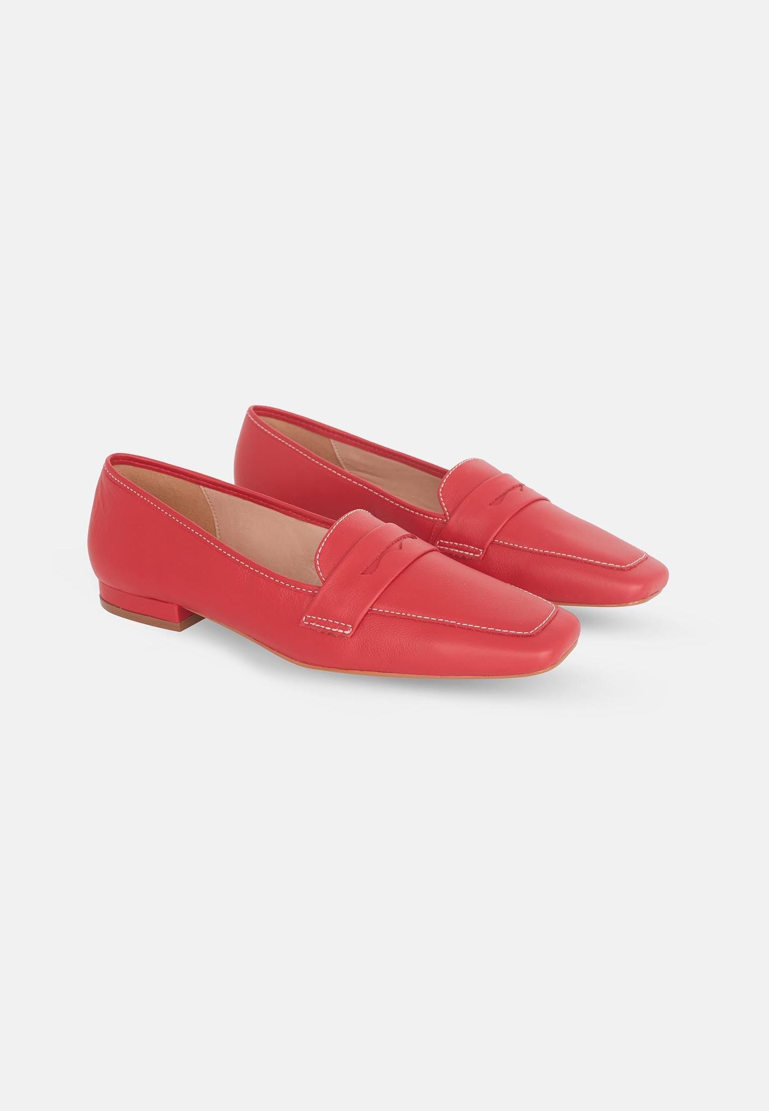 Pair of red loafers on a white background