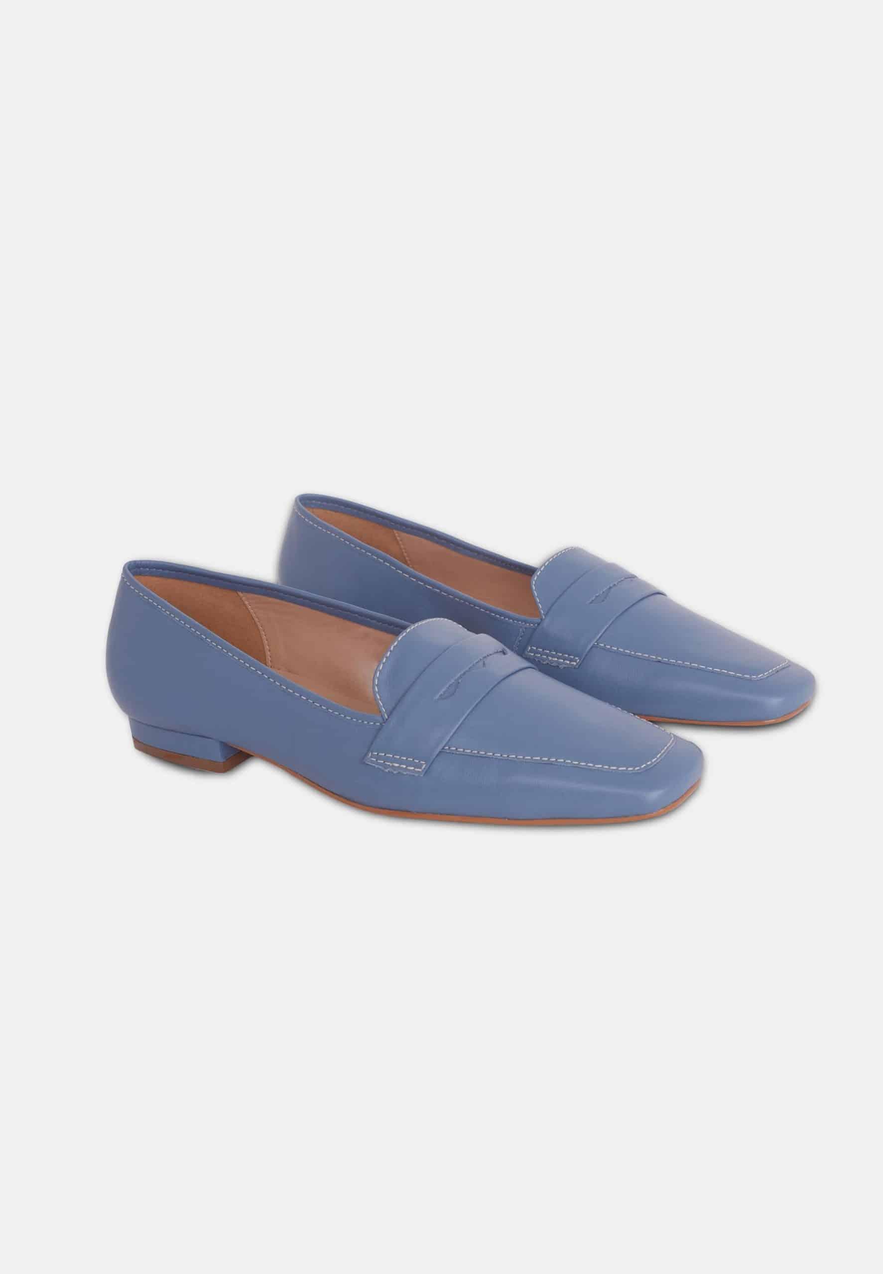 Pair of blue loafers on a white background