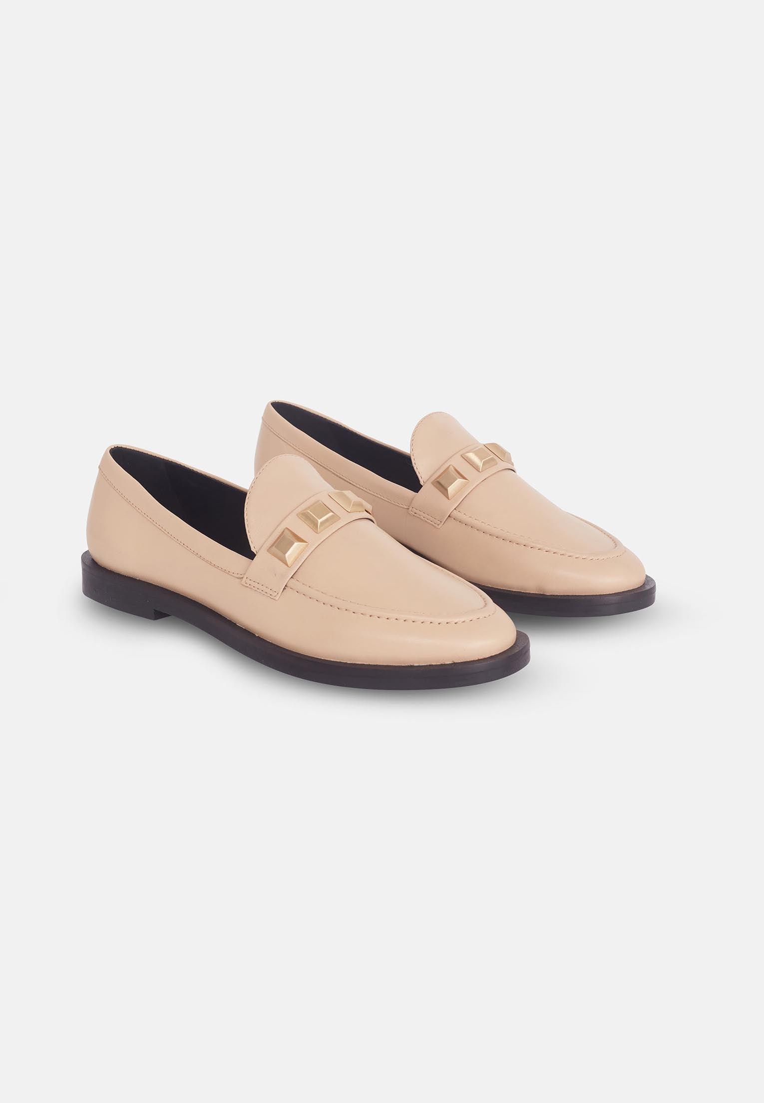 Pair of beige loafers on a white background