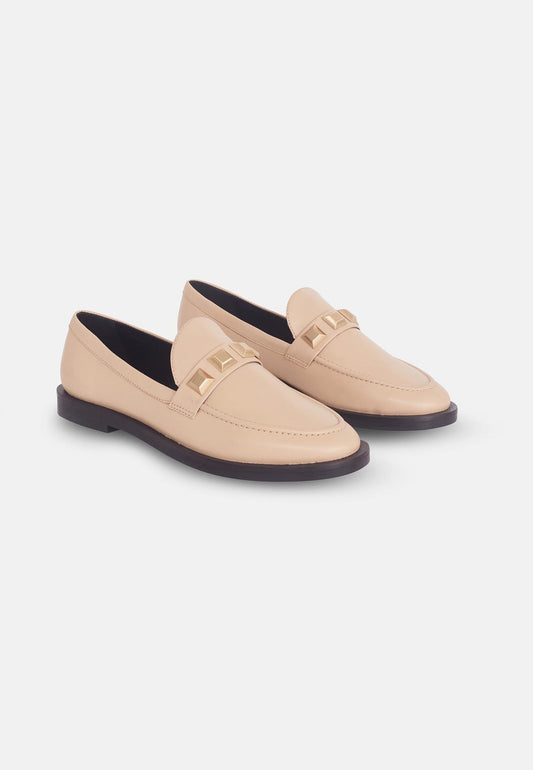 Pair of beige loafers on a white background