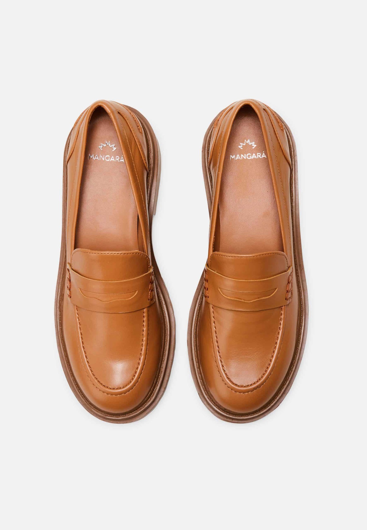 Pair of tan loafers on a white background