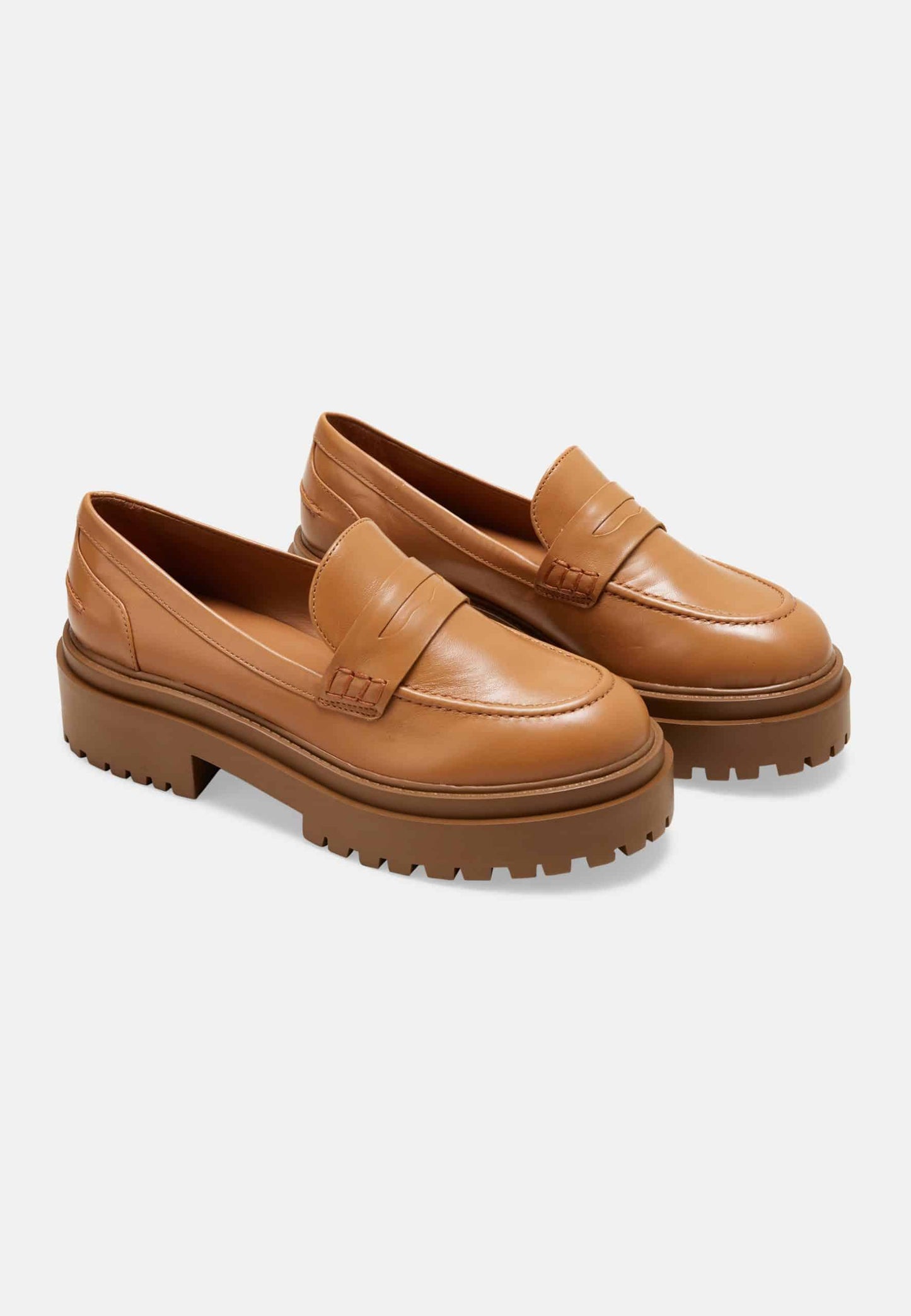 Pair of brown loafers on a white background