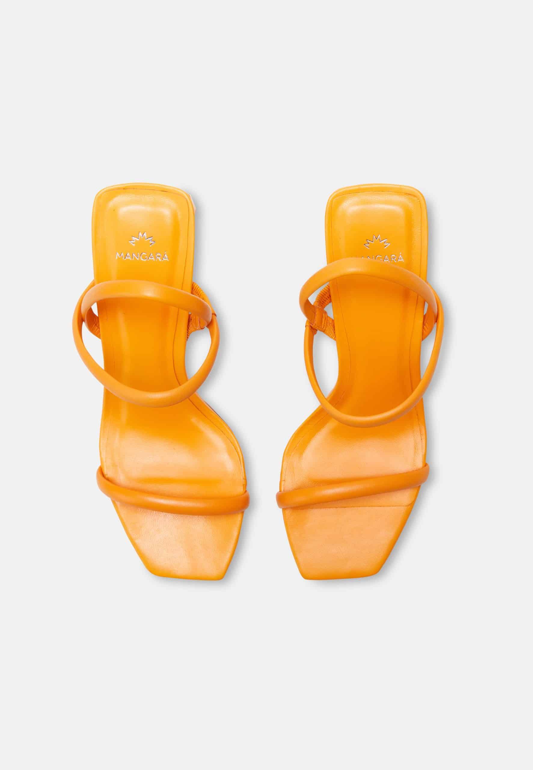 Pair of orange sandals with a clear jelly-like material on a white background