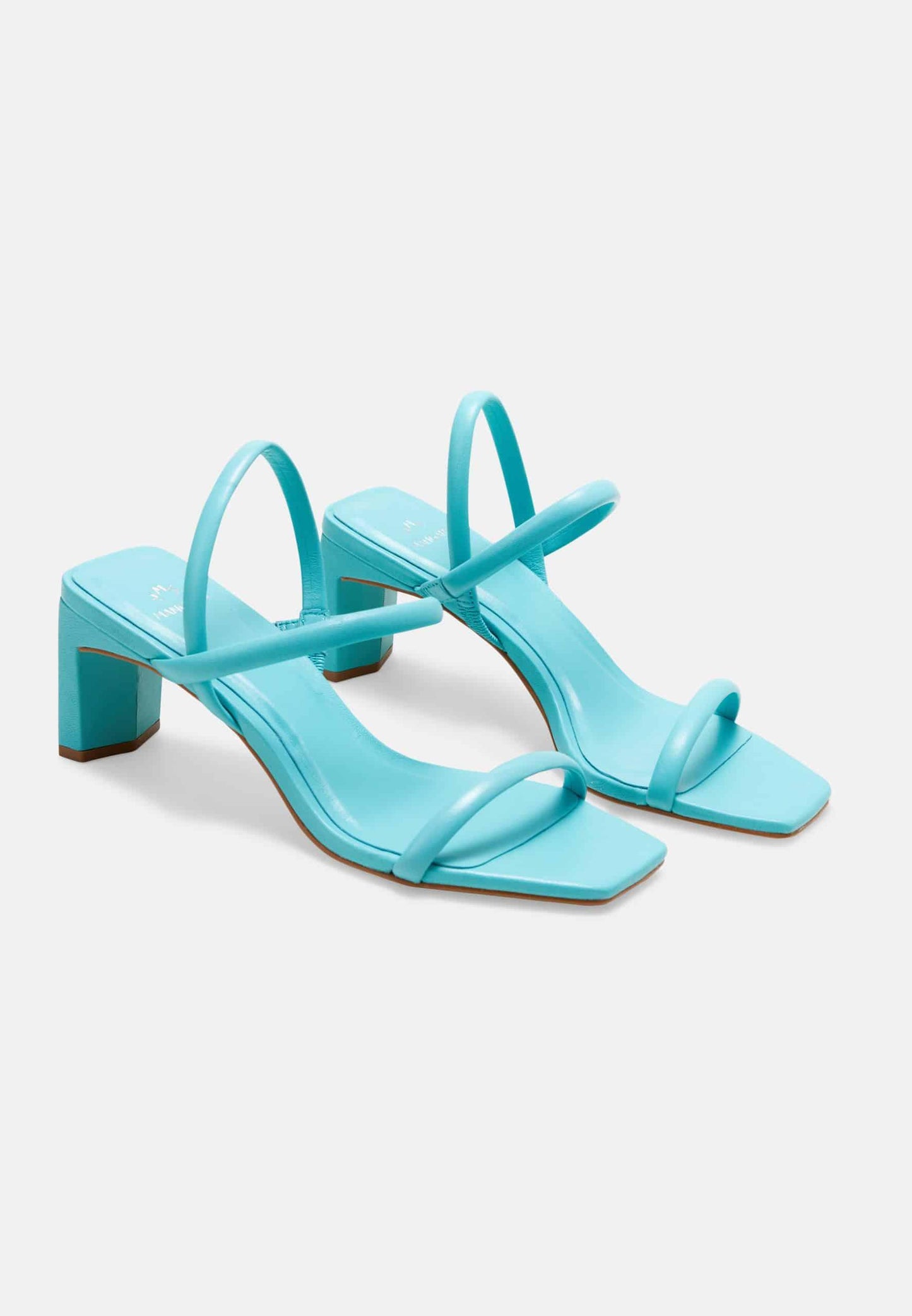 Pair of turquoise high-heeled sandals on a light gray background
