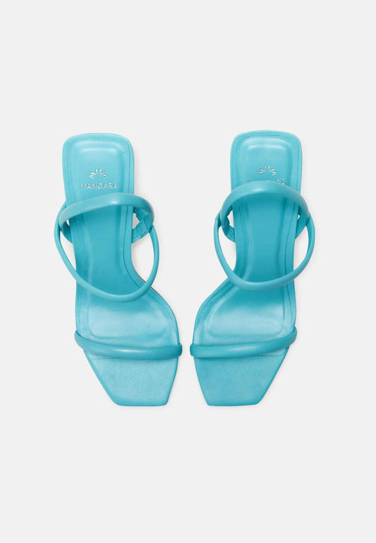Pair of turquoise high-heeled sandals on a white background