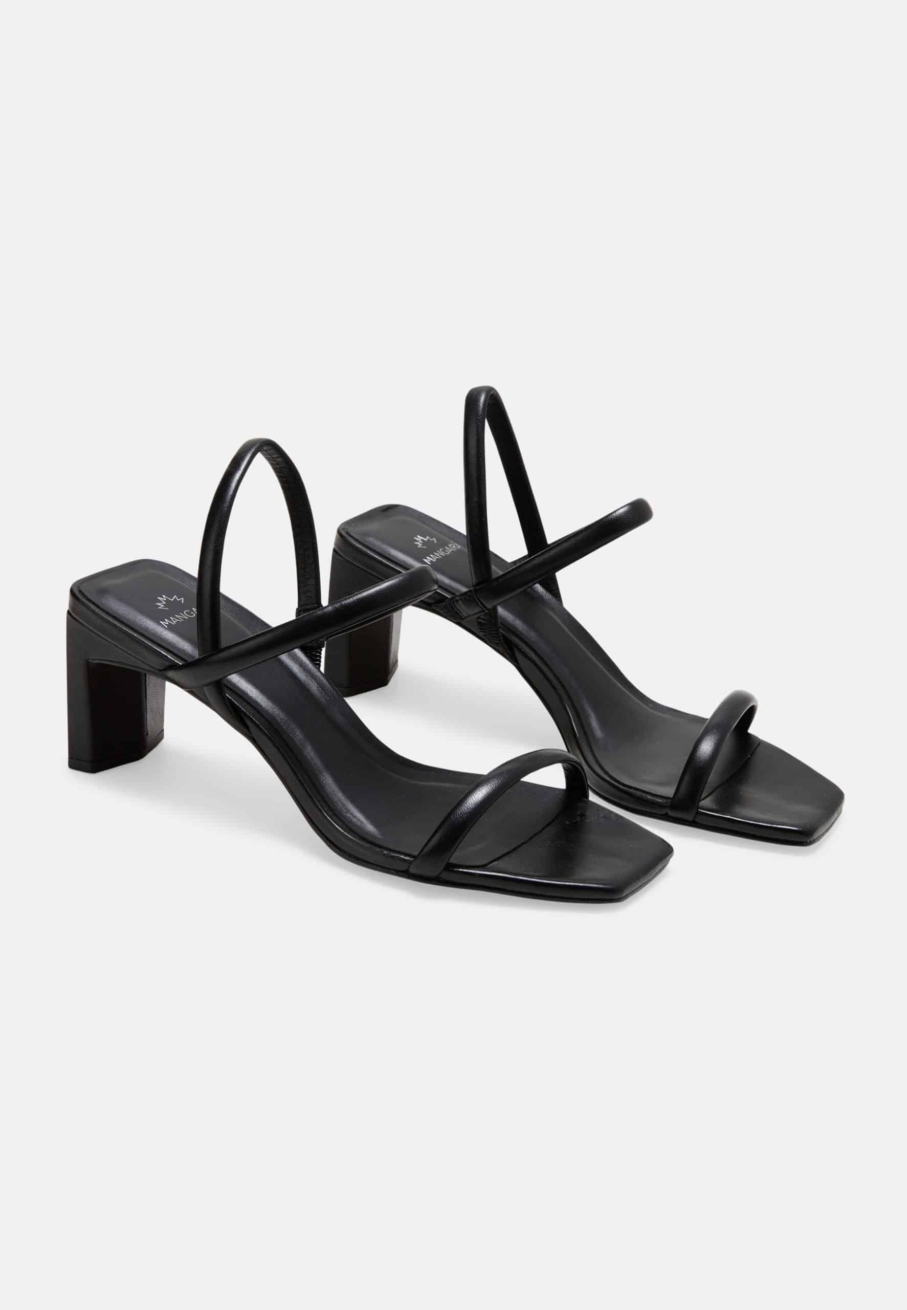 Black high-heeled sandals on a white background