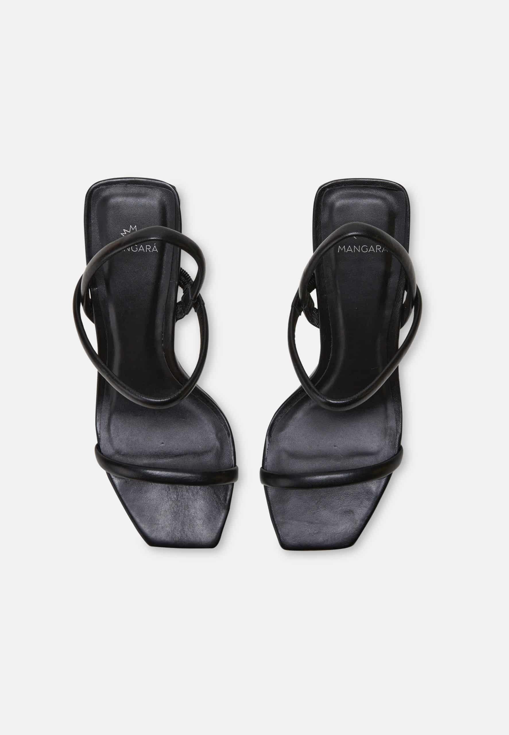 Black high-heeled sandals with strappy design on a white background