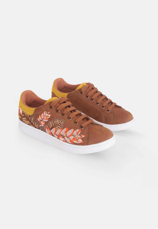 Brown sneakers with floral pattern on a white background
