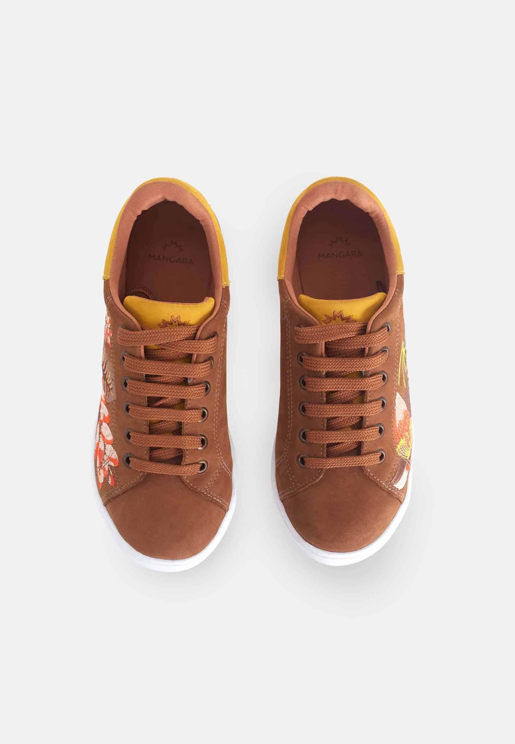 Brown sneakers with floral patterns on a white background