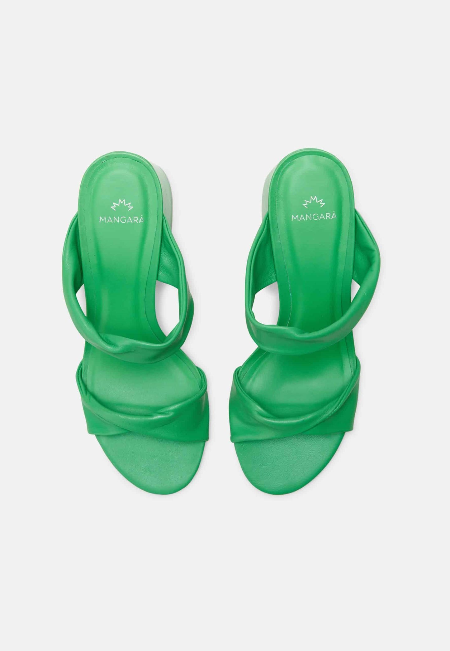 Green high-heeled sandals on a light gray background