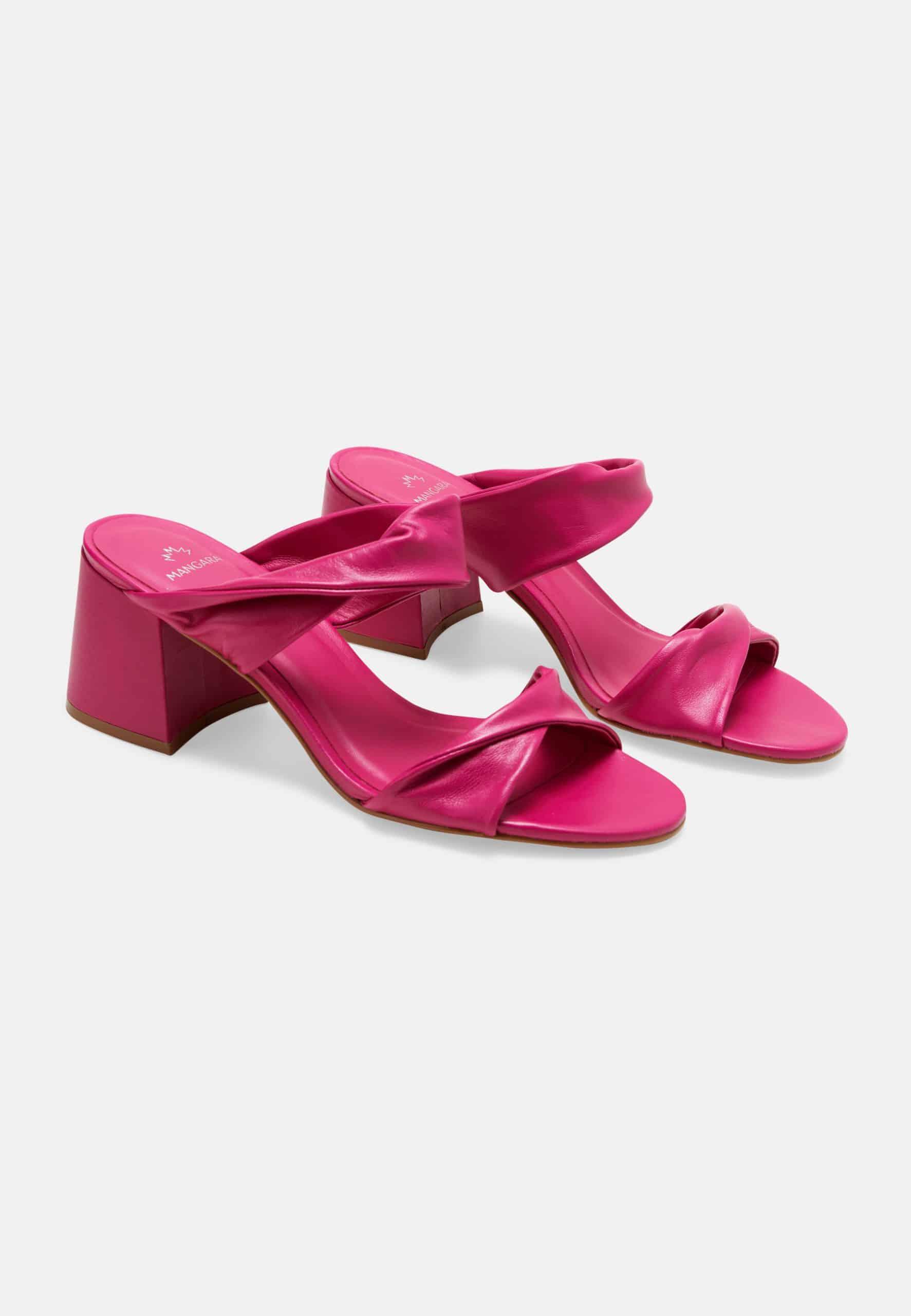Pair of bright pink sandals on a white background