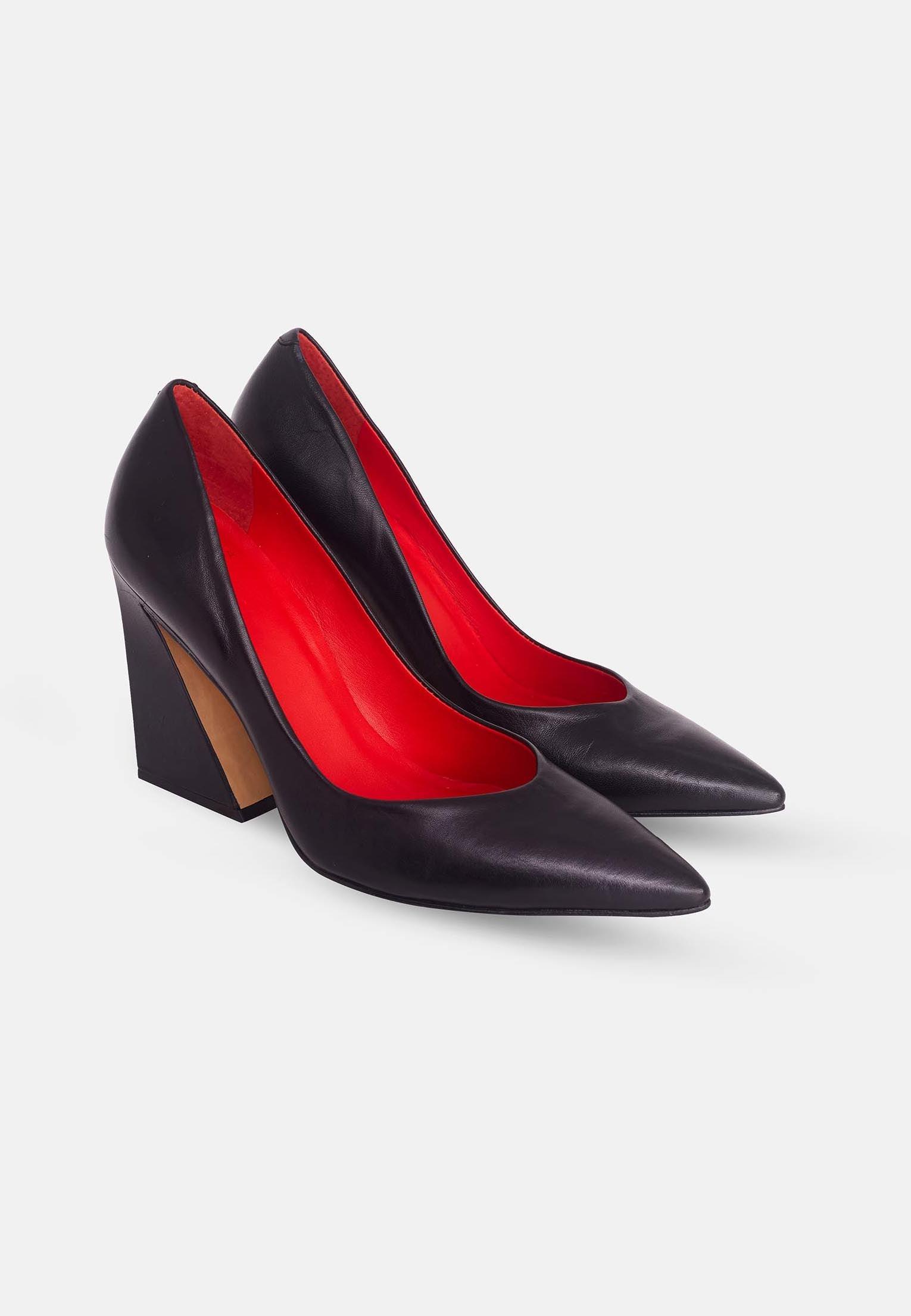 Black high-heeled shoes with red interior on a white background