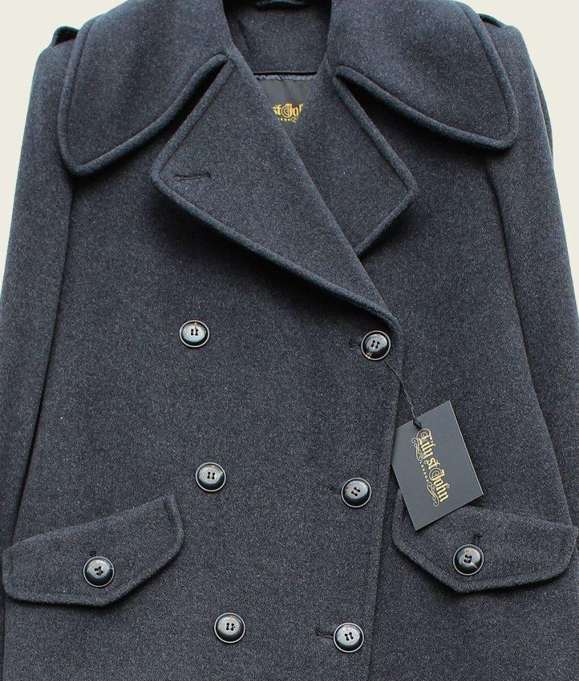 Gray coat with a tag on a beige background