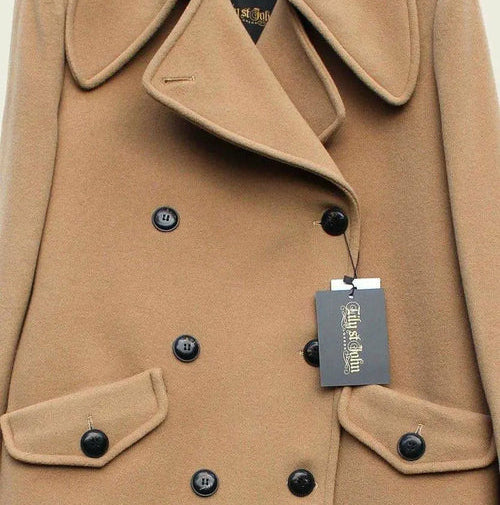 Tan coat with black buttons and a visible tag