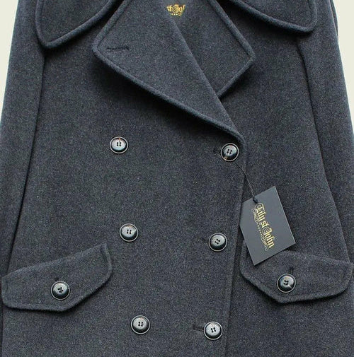 Gray coat with a tag and British flag in the corner on a beige background