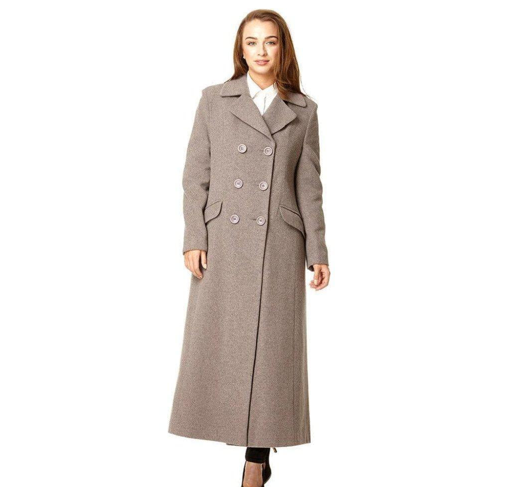 Woman wearing a long gray coat on a white background