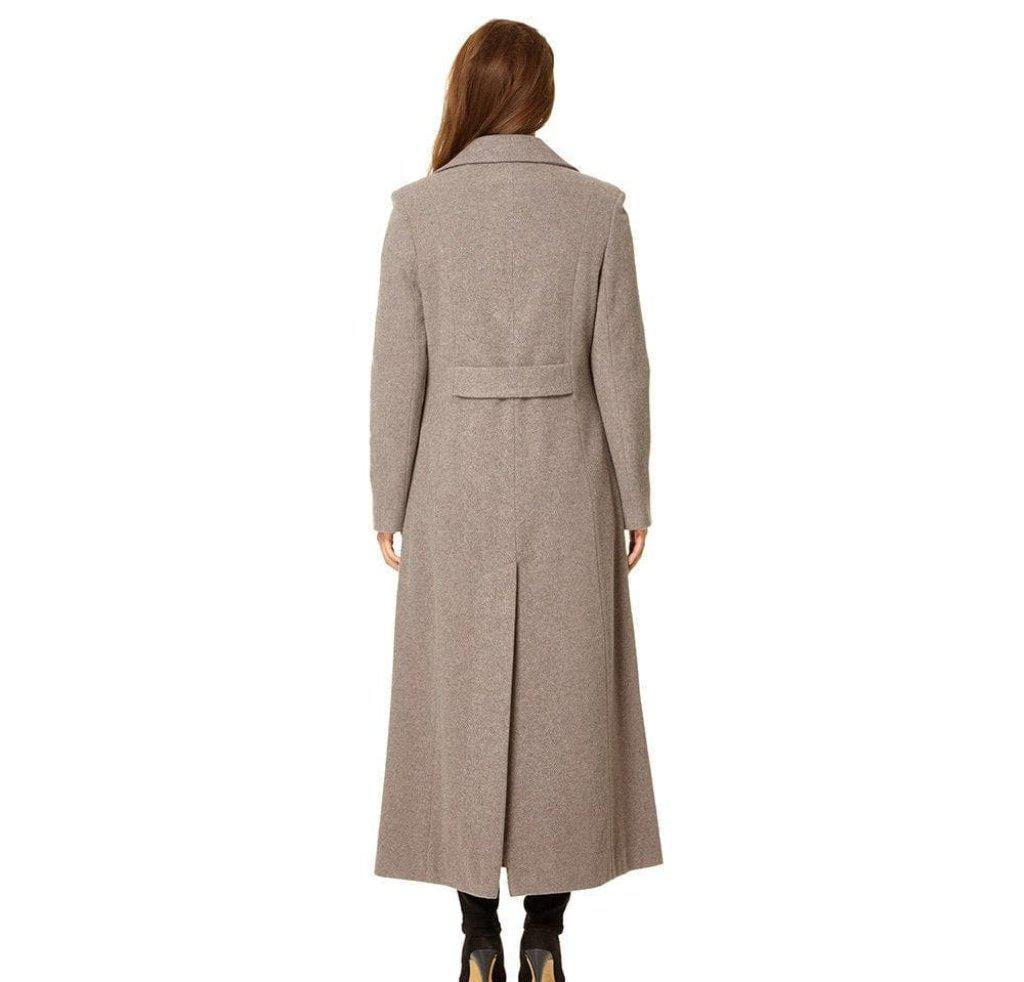 Woman wearing a long beige coat on a white background