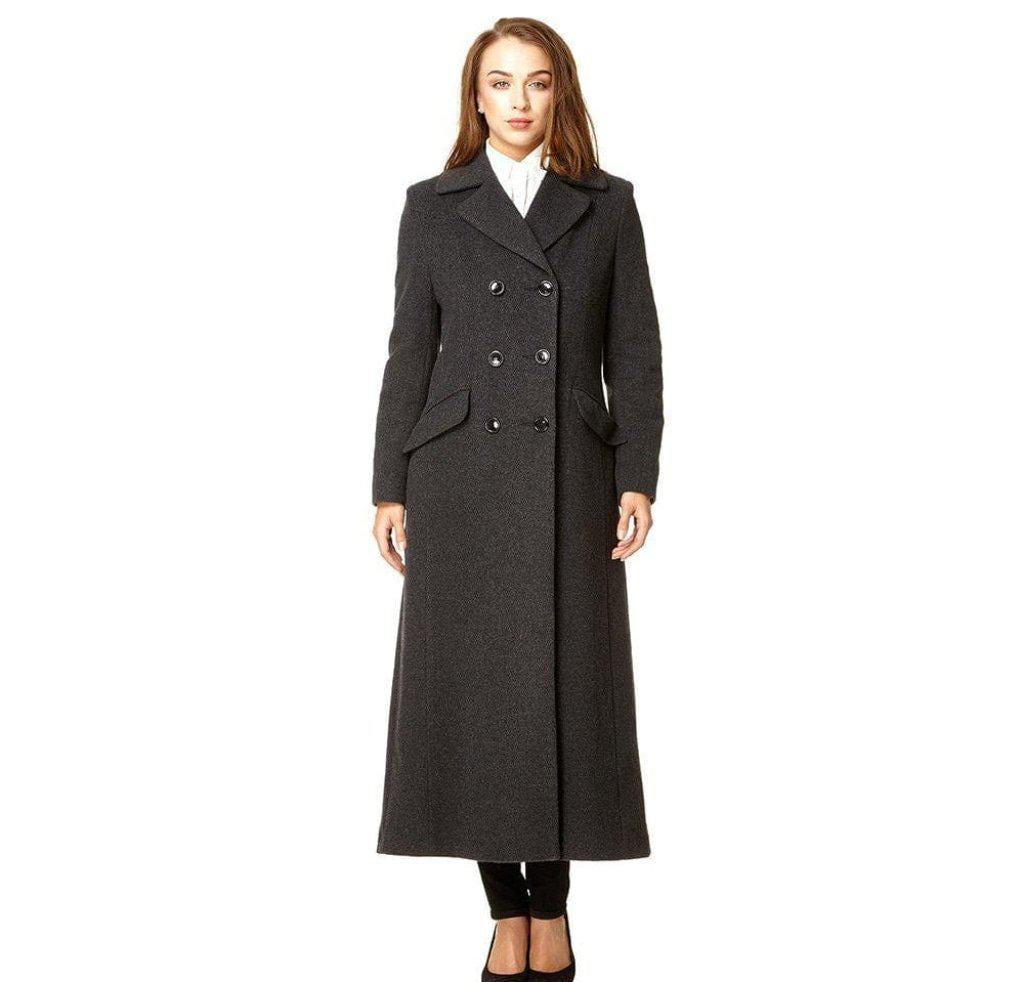 Woman wearing a long dark gray coat on a white background