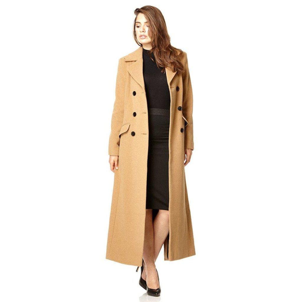 Woman wearing a long beige coat on a white background