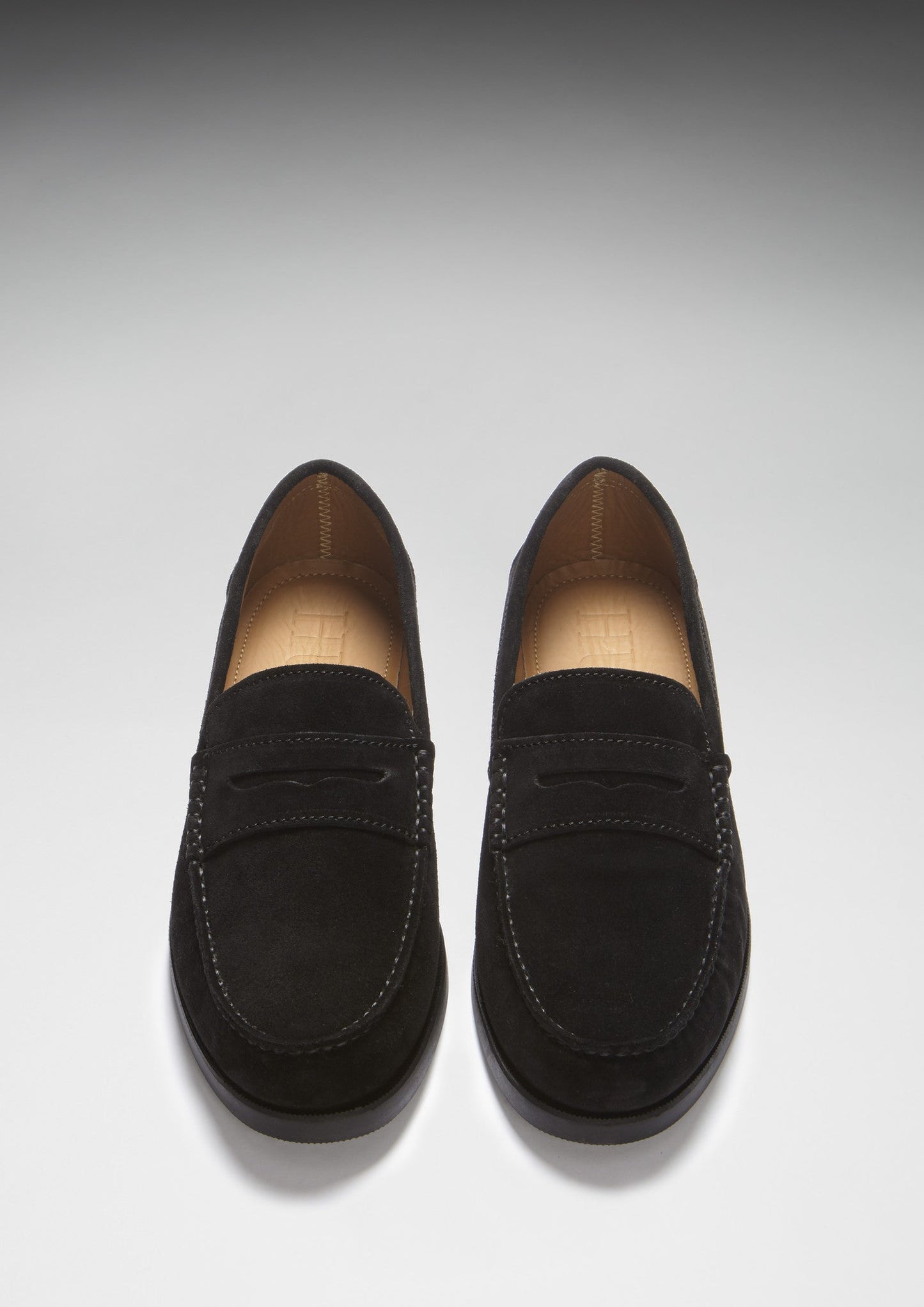 Pair of black loafers on a light gray background