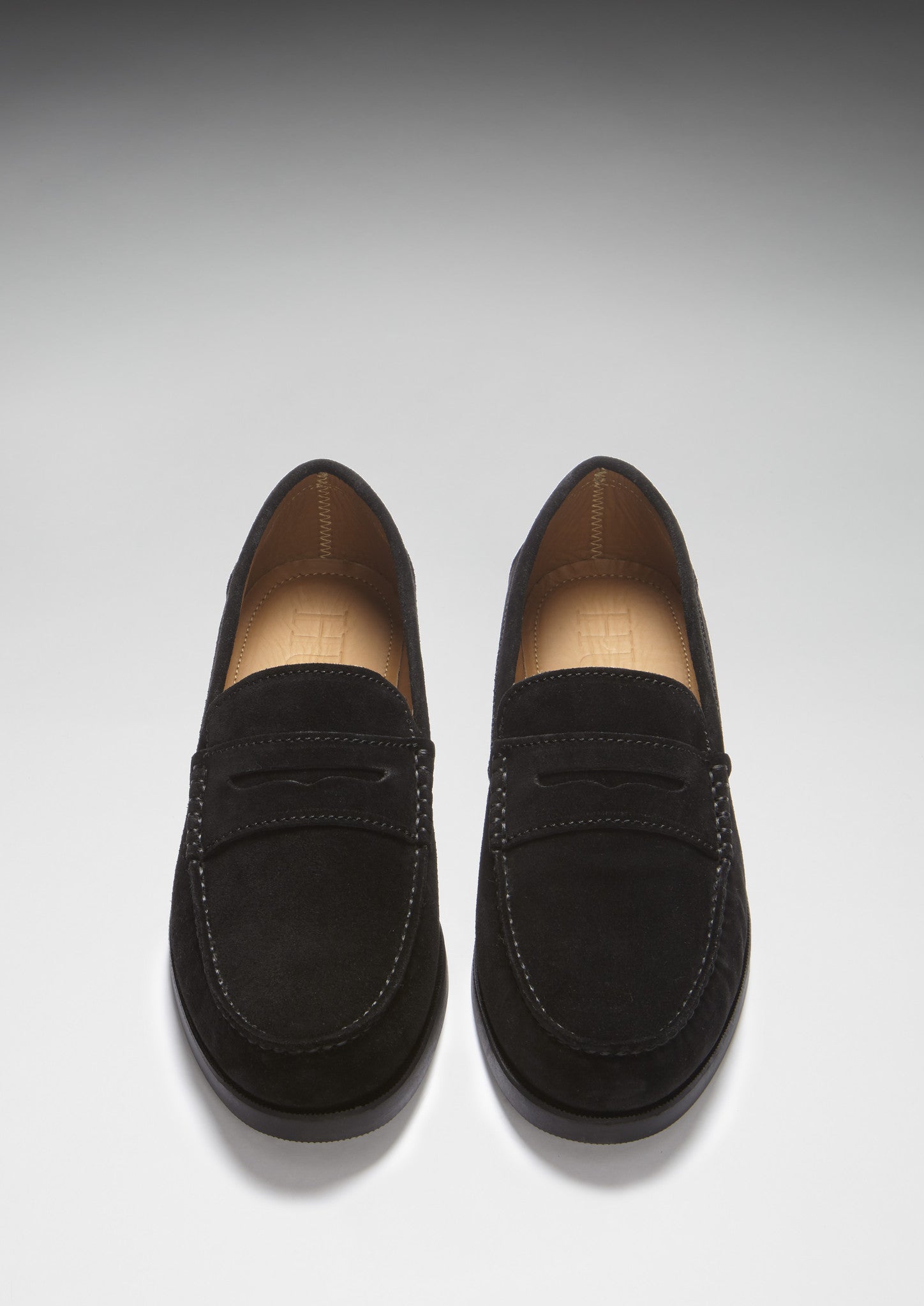Pair of black loafers on a light gray background