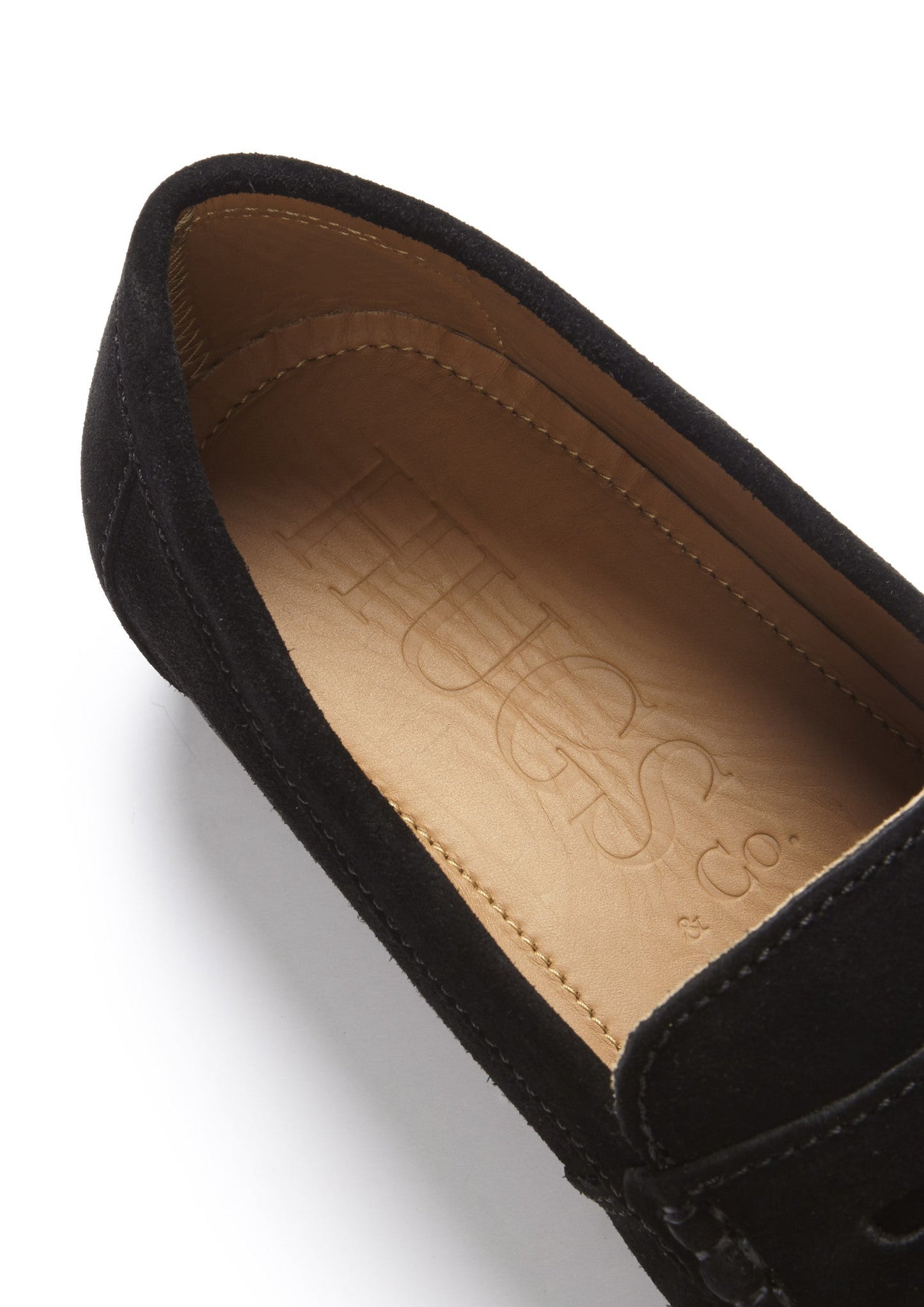 Black loafer with visible brand logo on a white background