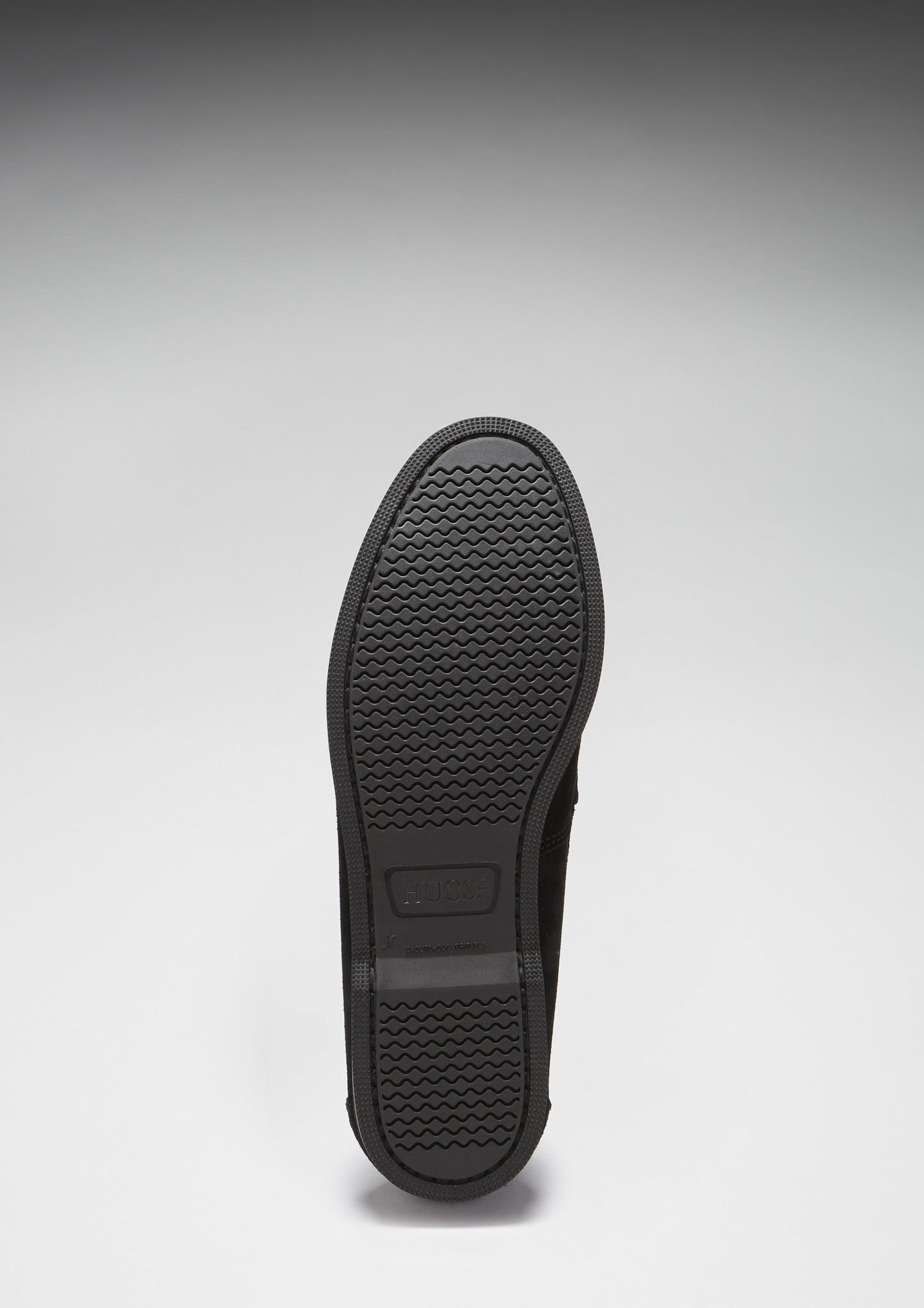 Black shoe sole on a light gray background