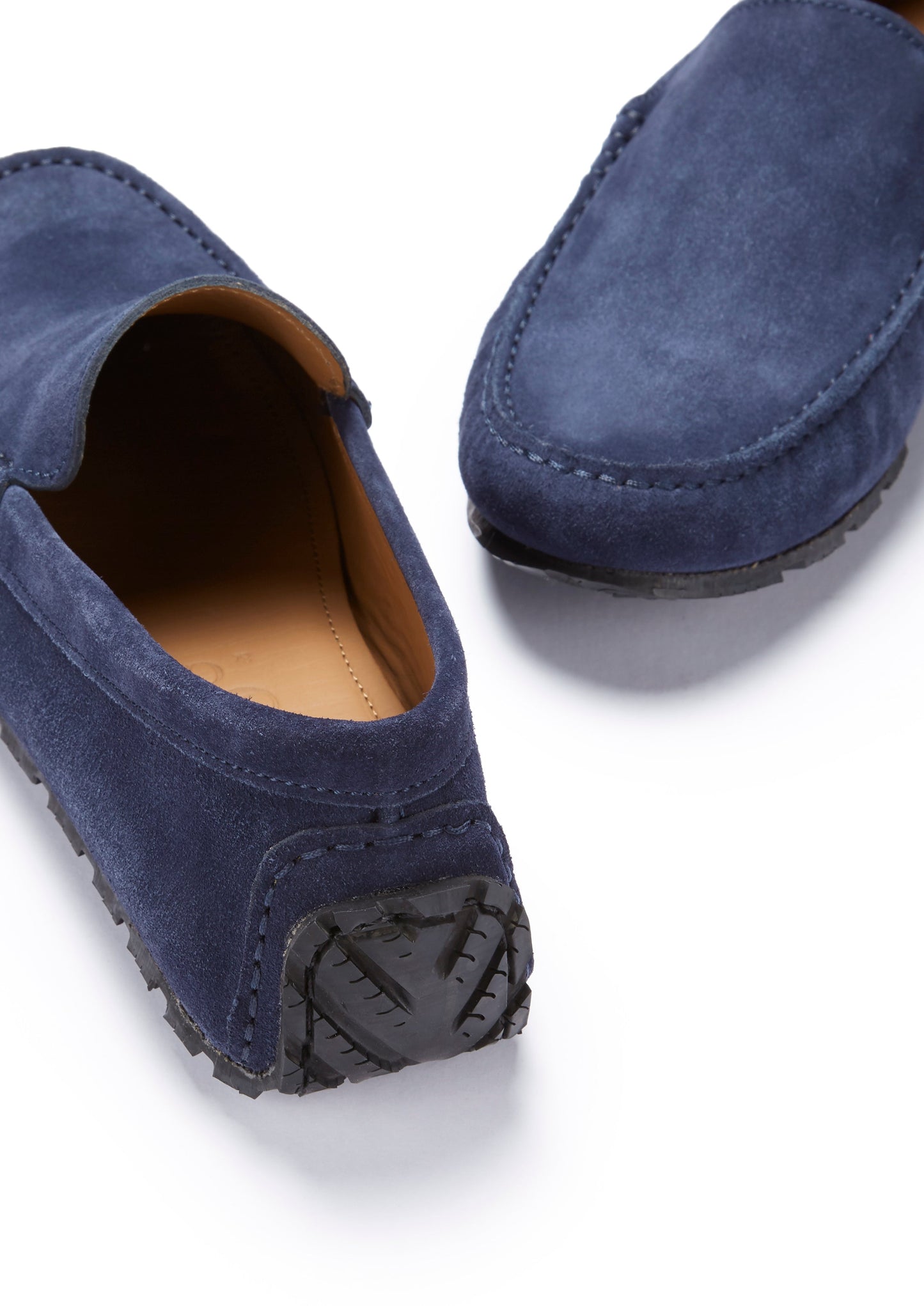 Pair of blue suede loafers on a white background