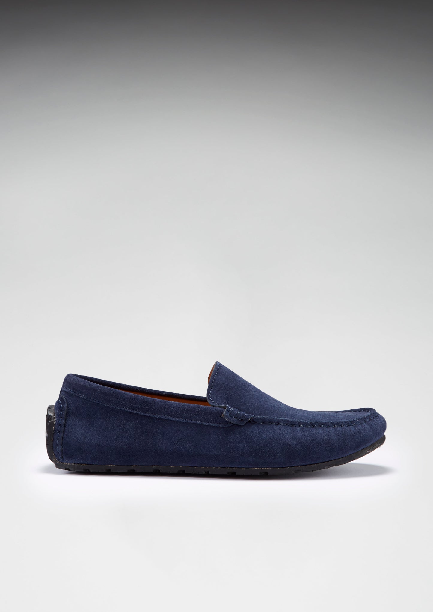 Navy blue loafer shoe on a light gray background
