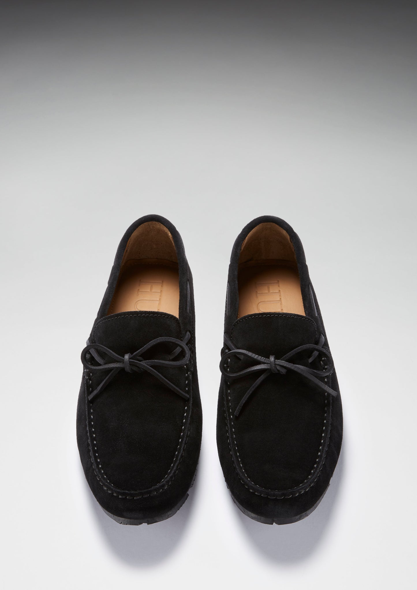 Pair of black loafers on a light gray background