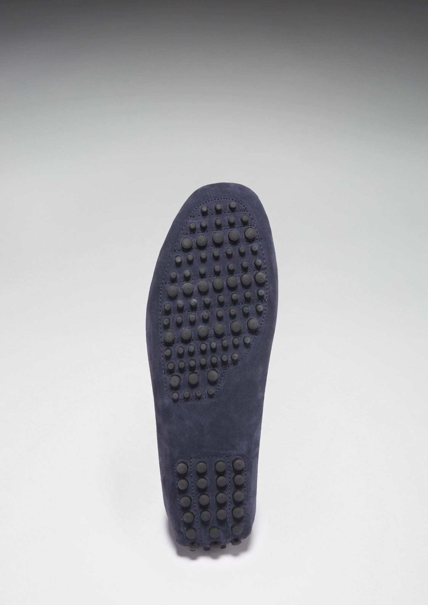 Dark blue shoe sole with tread pattern on a light gray background