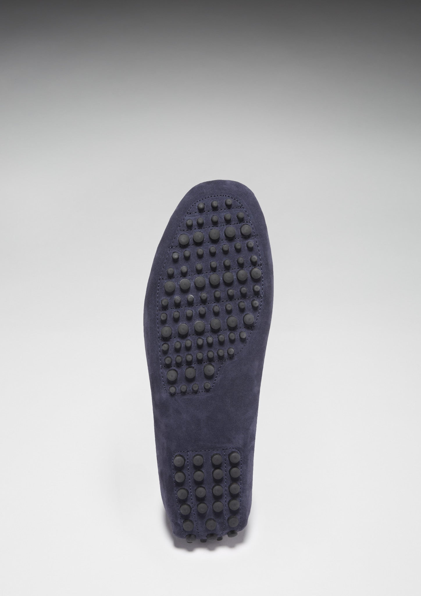 Dark blue shoe sole with tread pattern on a light gray background