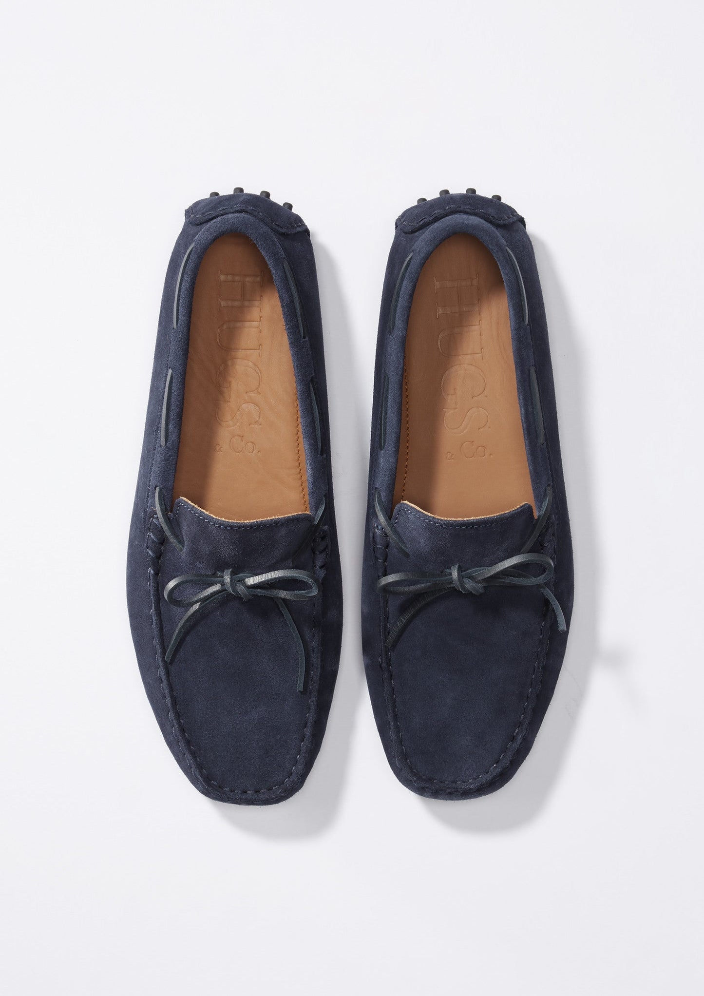 Pair of navy blue loafers on a light gray background