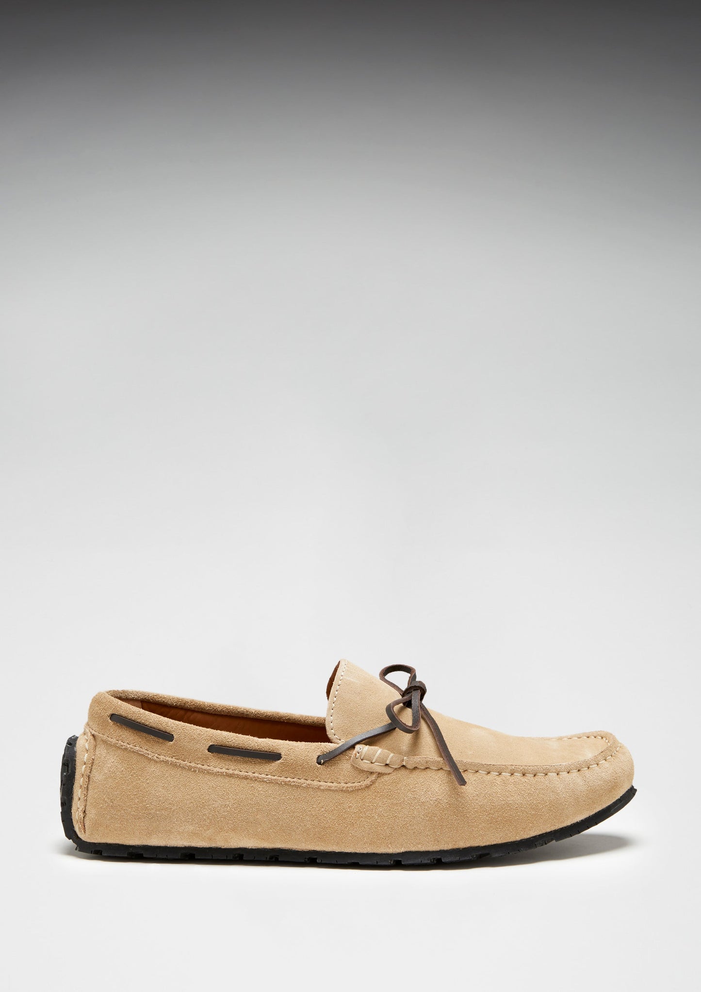 Beige loafer shoe on a light gray background