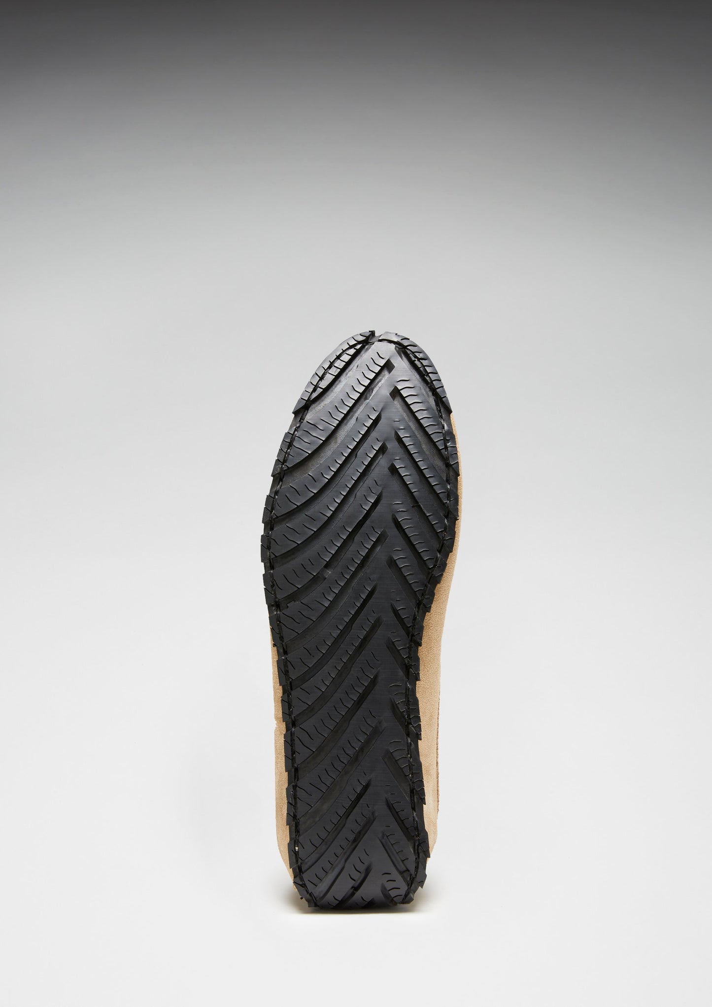 Black sole of a shoe on a gray background