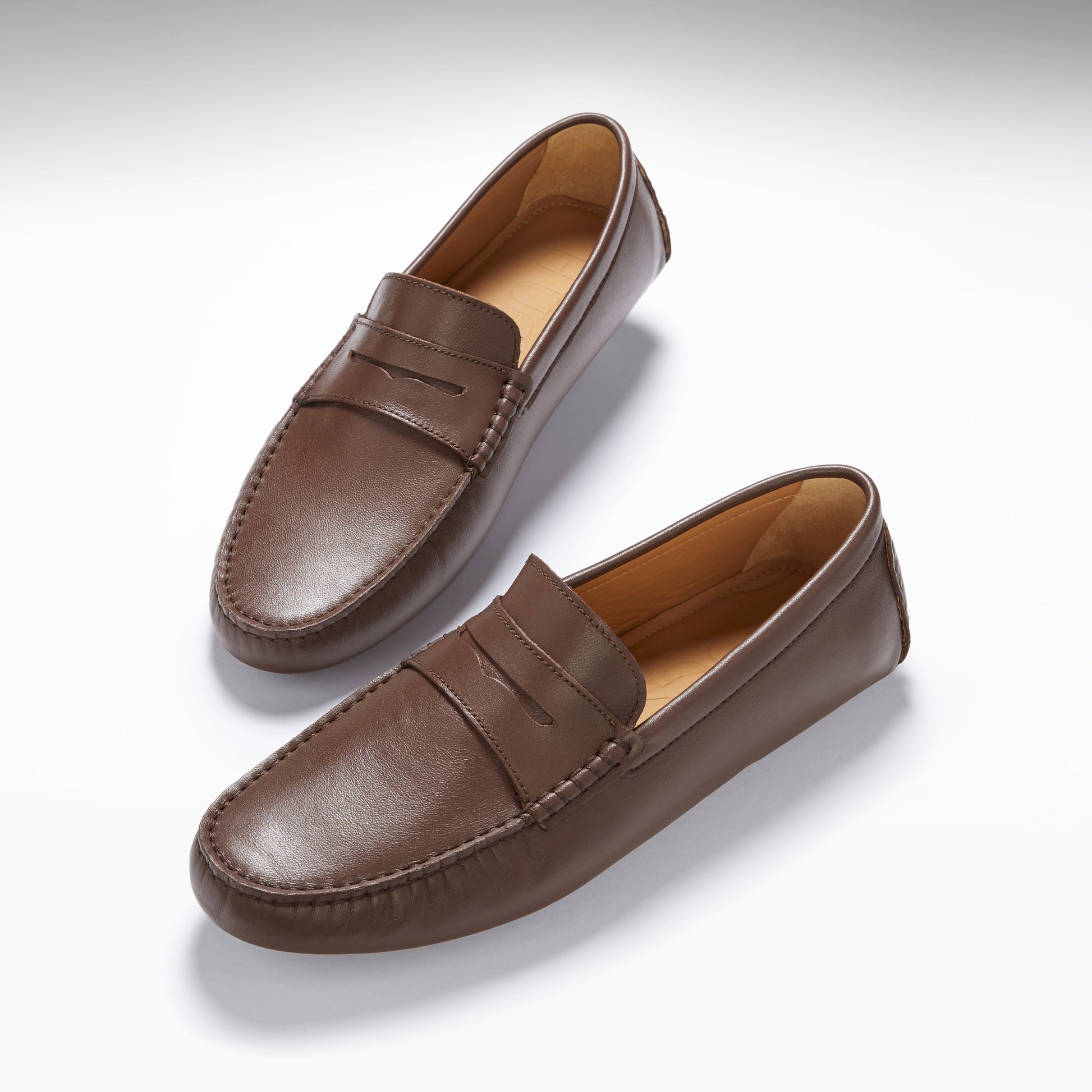 Pair of brown loafers on a white background