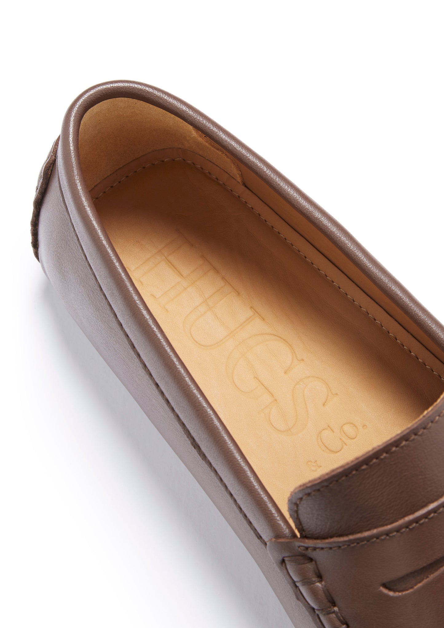 Brown leather loafer with visible brand logo on a white background